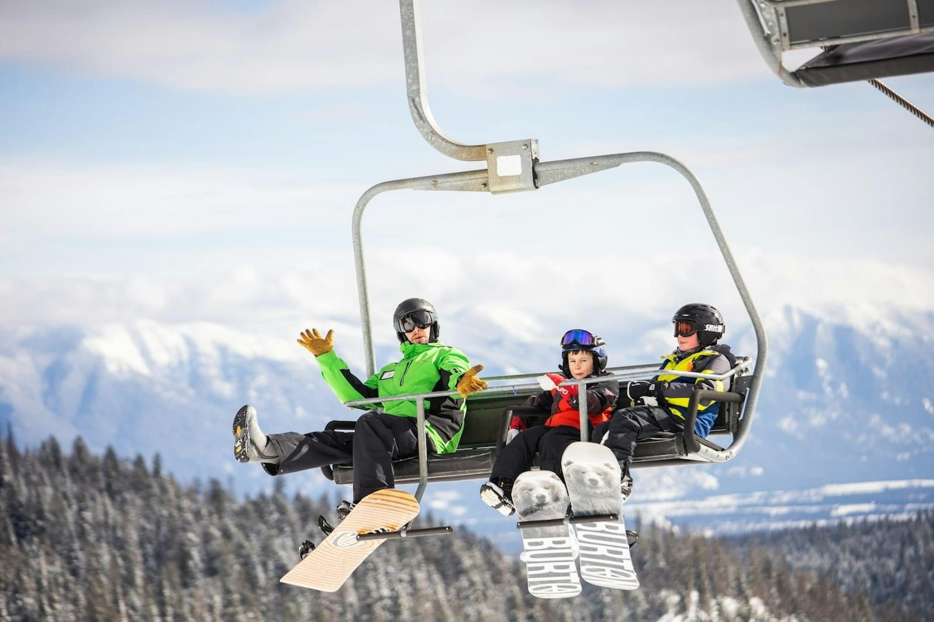 Snowboarders on chairlift at Whitefish Mountain Resort.