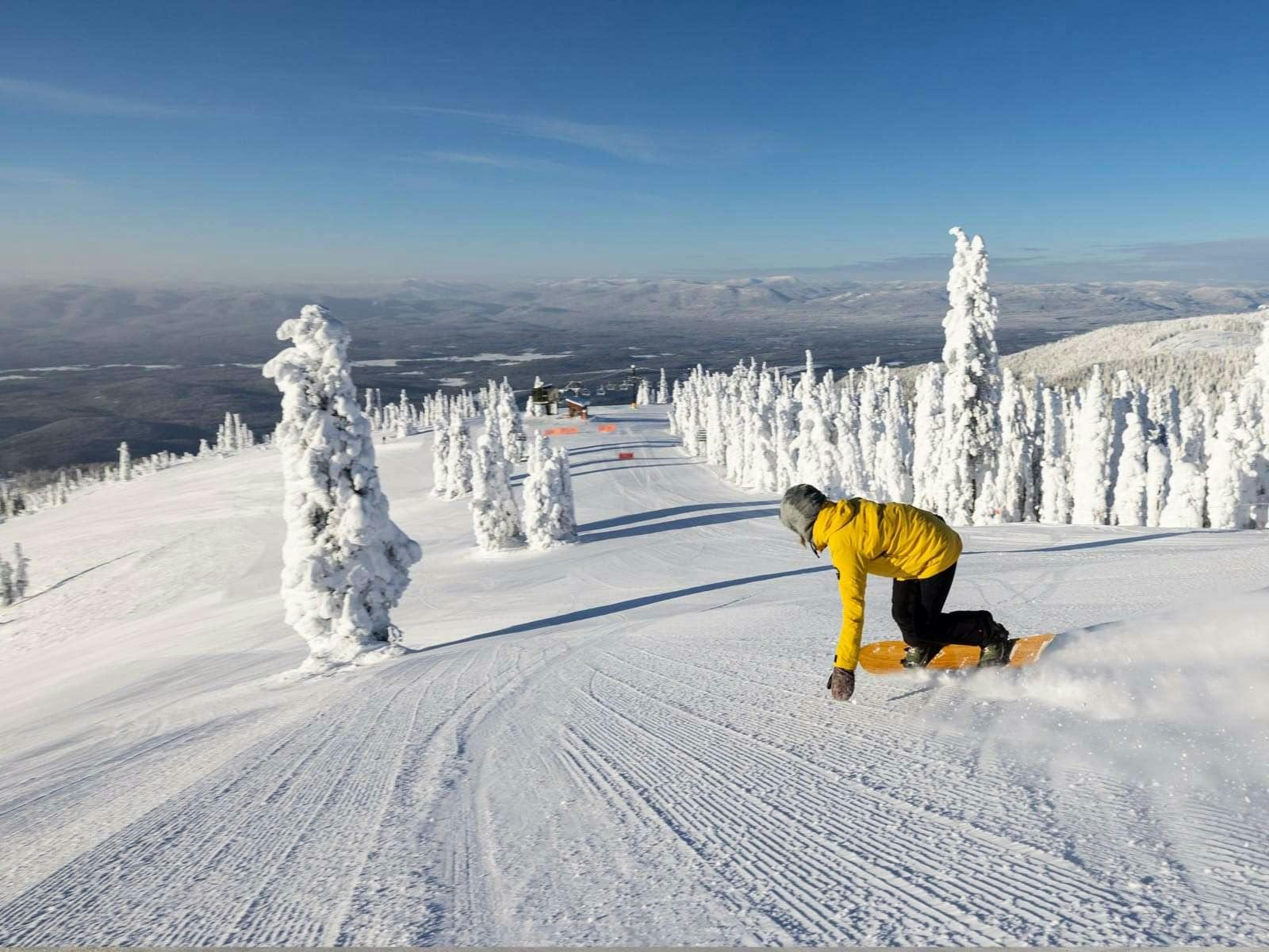Snowboarder on groomed run at Whitefish Mountain Resort.