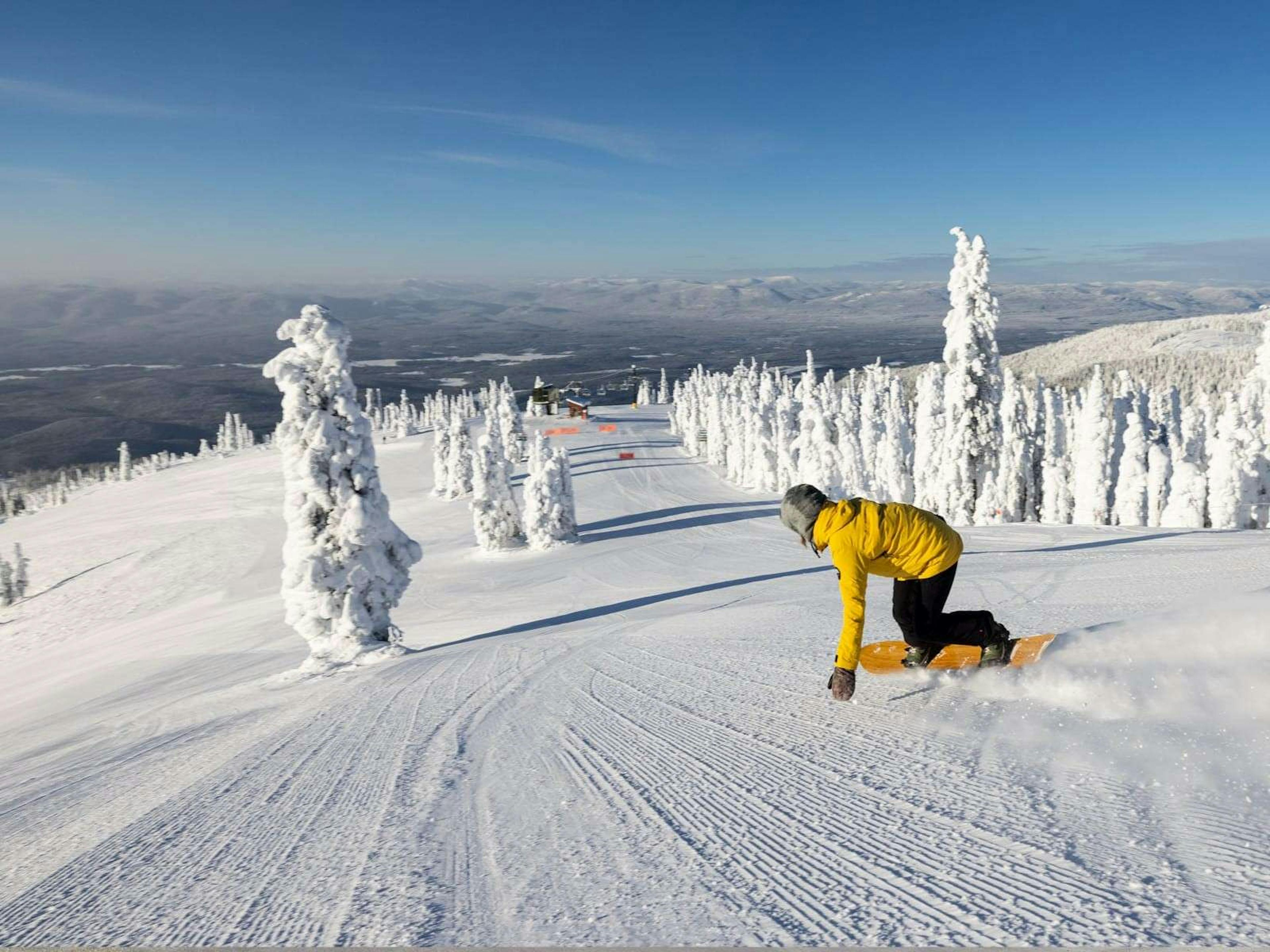 Snowboarder on groomed run at Whitefish Mountain Resort.