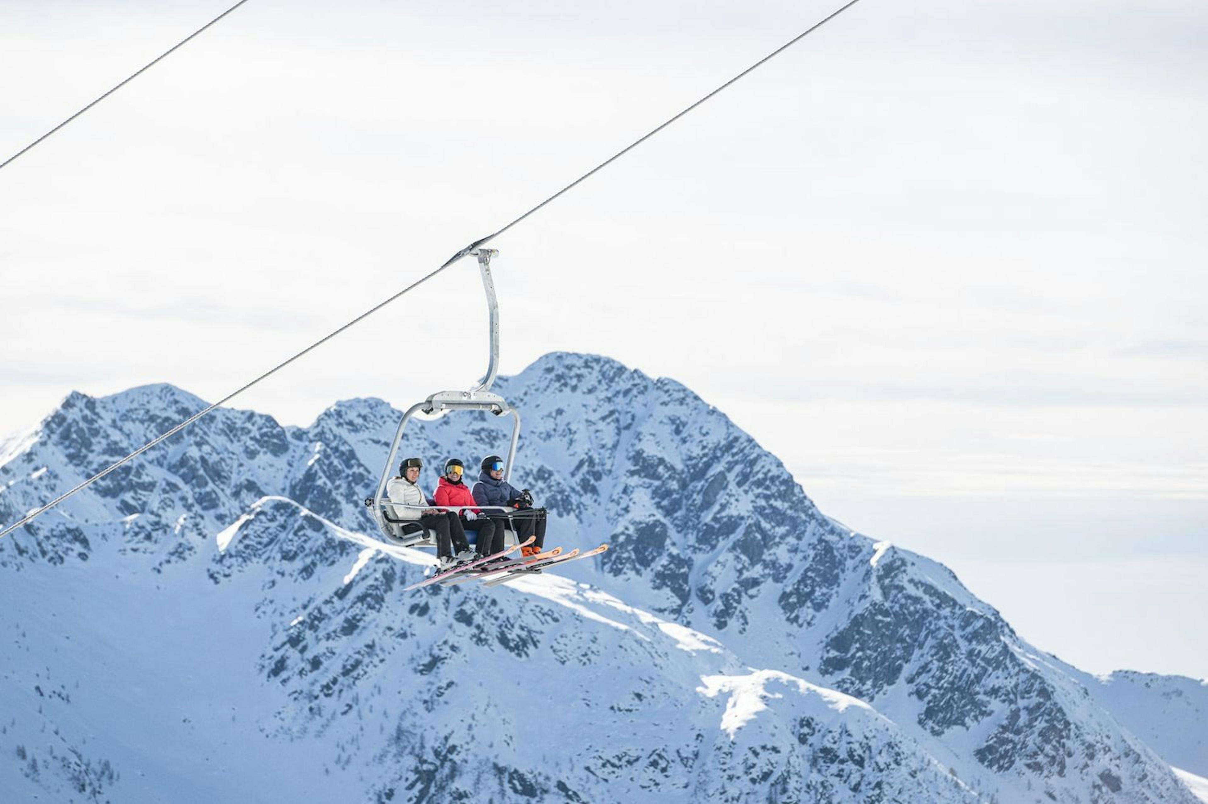 Skiers on lift in Arabba Marmolada in Italy