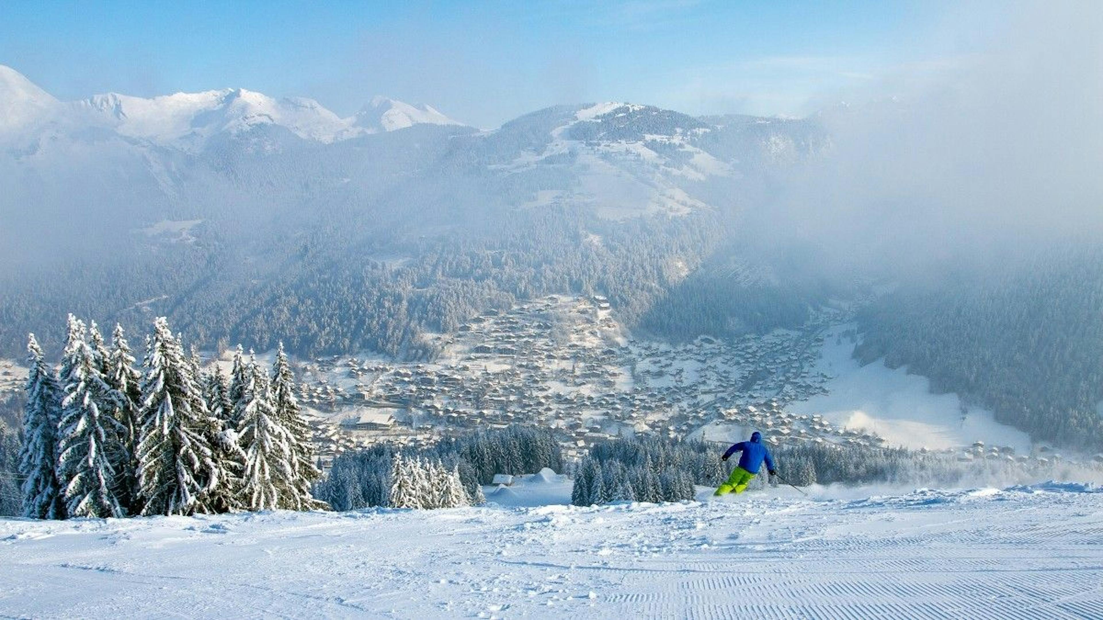 Skier with view of village at Morzine