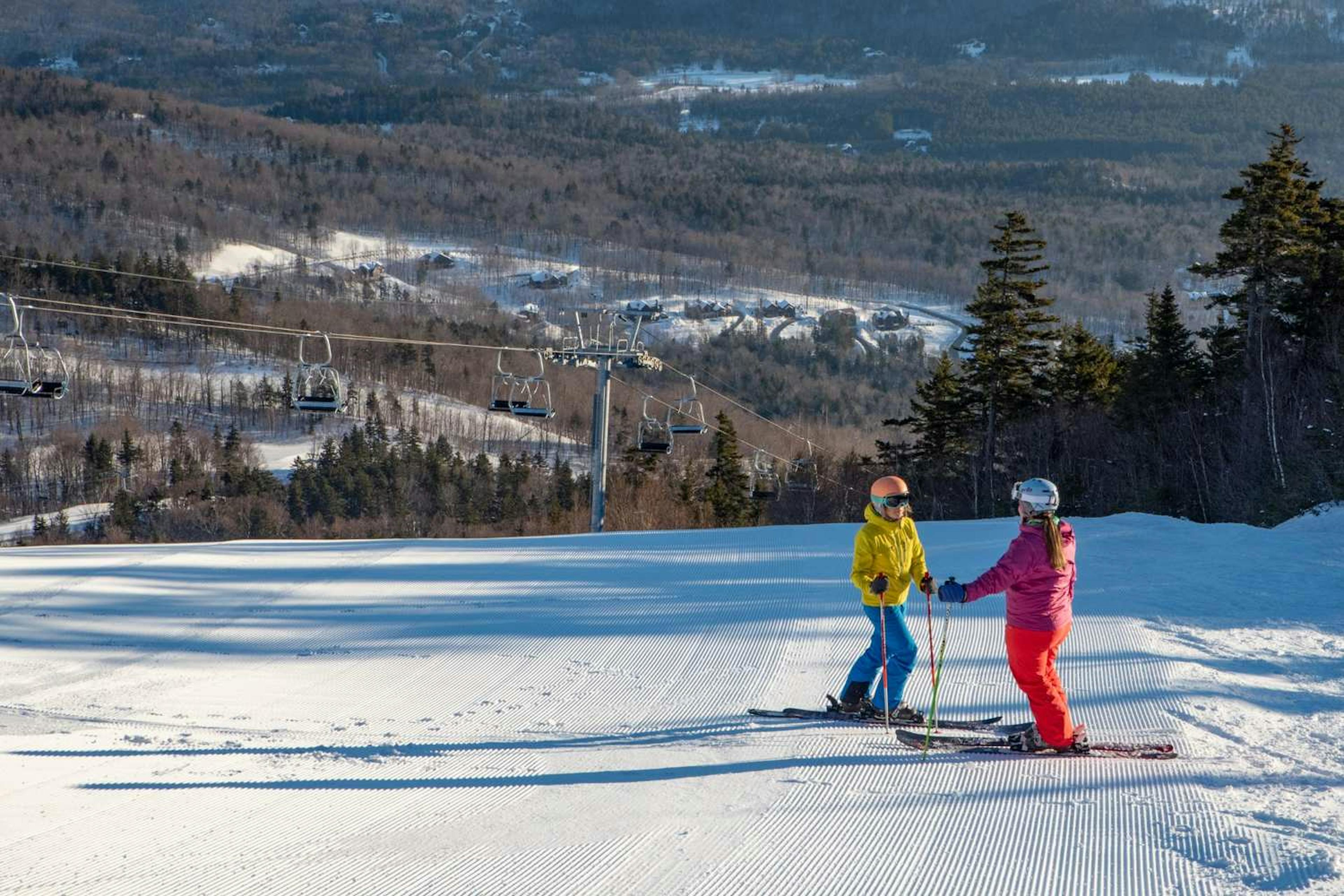 Two skiers skiing in Sunday River.