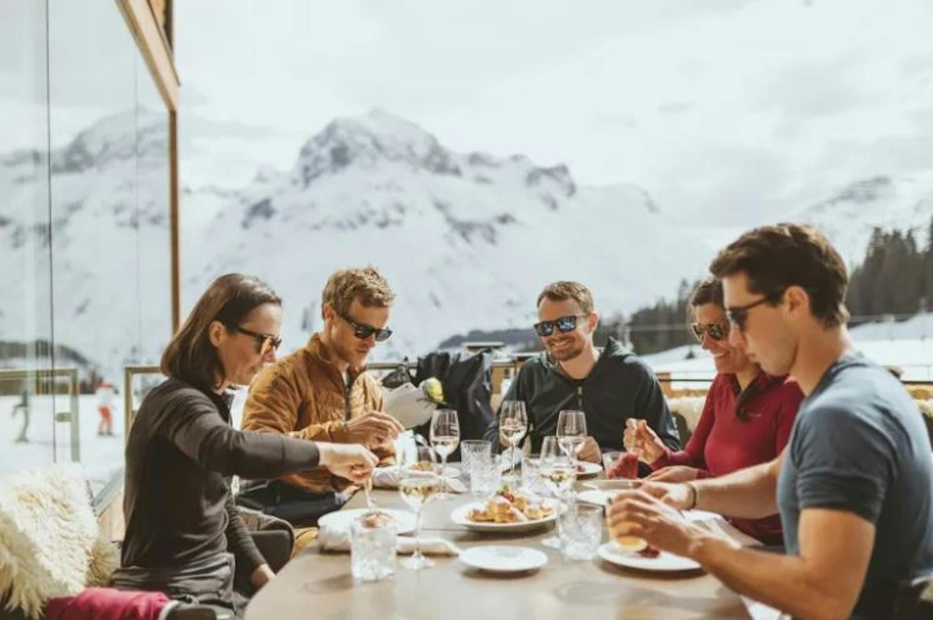 People enjoying an authentic Austrian meal in the mountains in Austria.