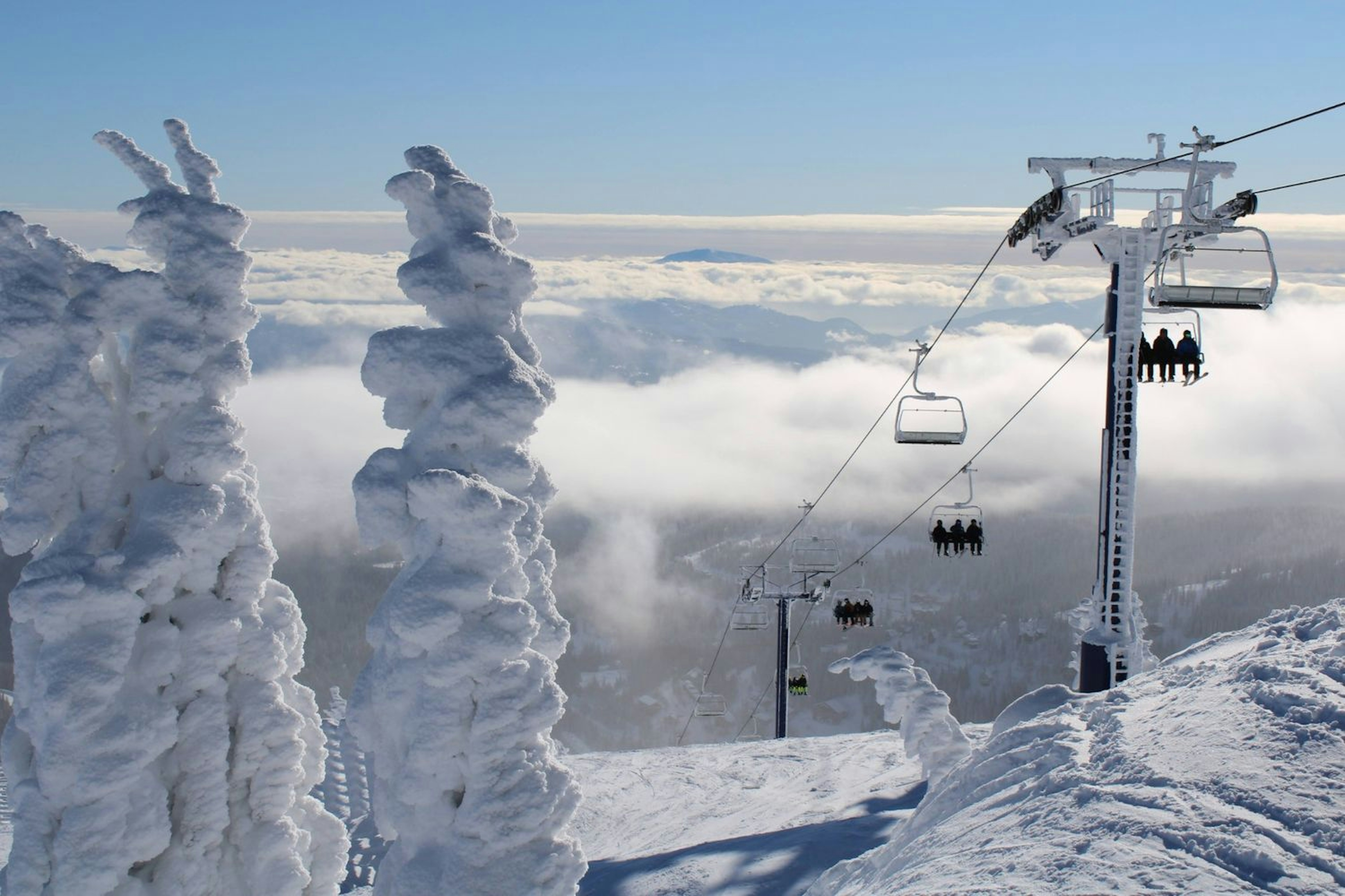 View of a chairlift and fresh snow on the trees at Schweitzer Mountain Resort