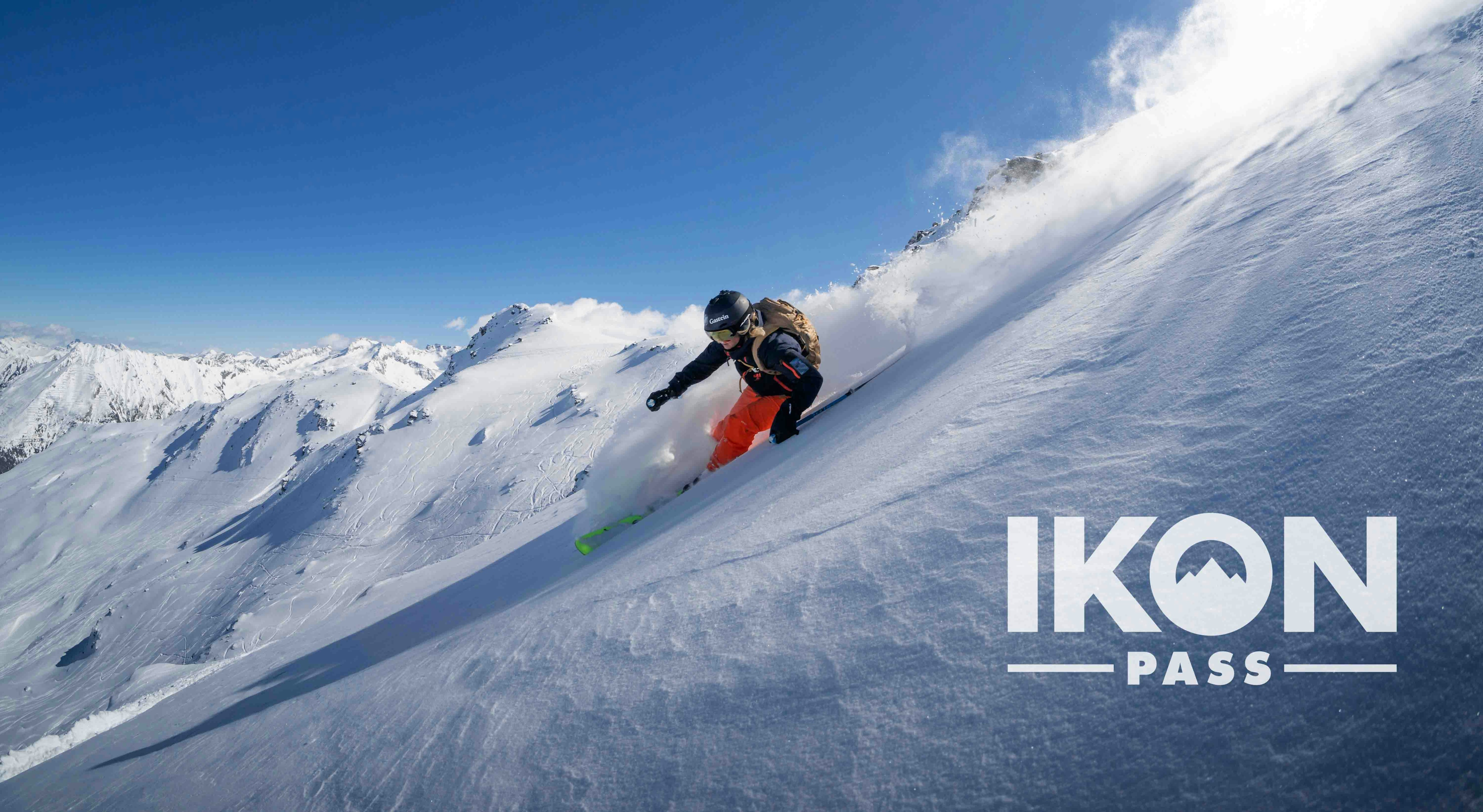 A skier skiing deep powder at an Ikon Pass resort.