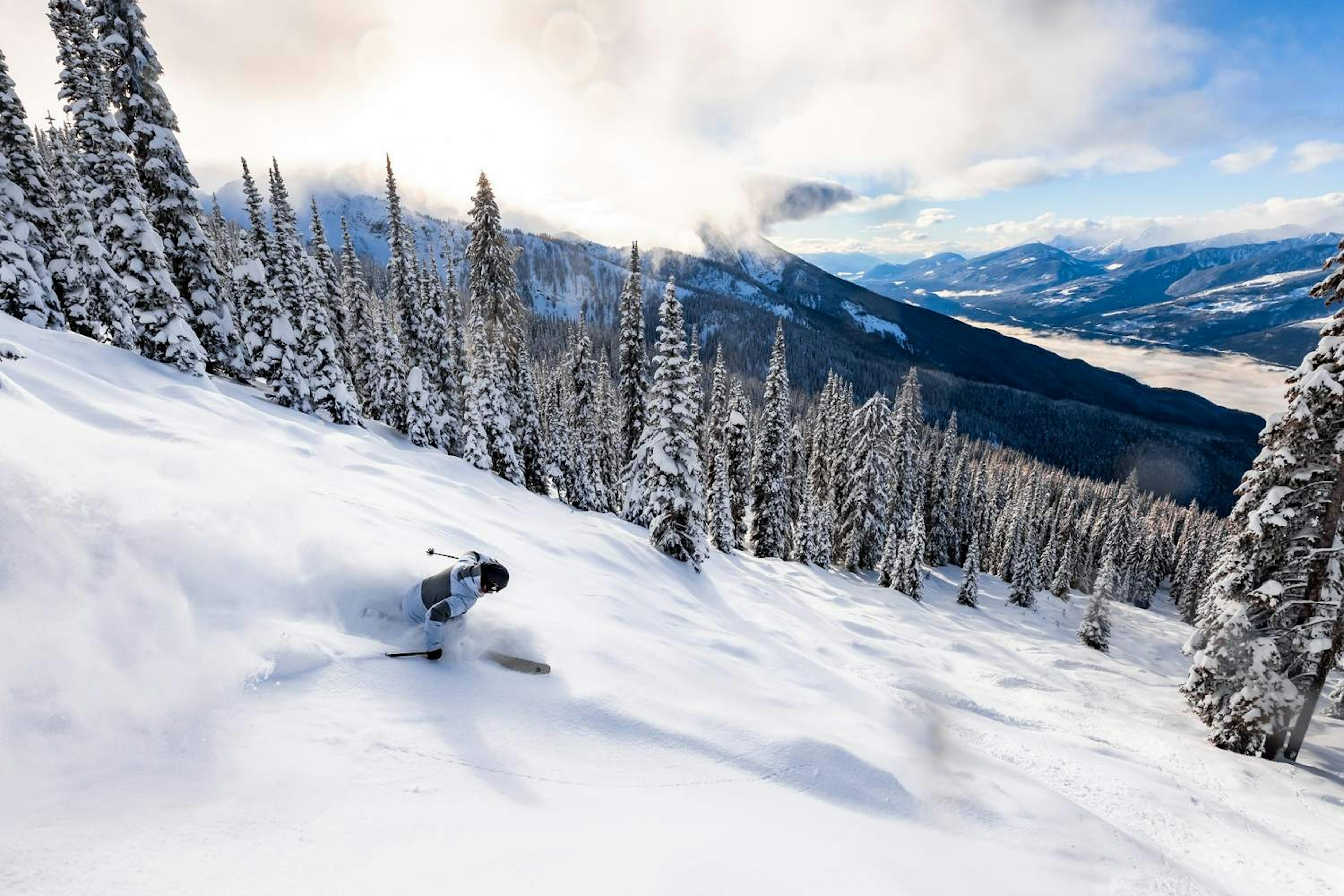 A skier navigates a snowy slope in British Columbia