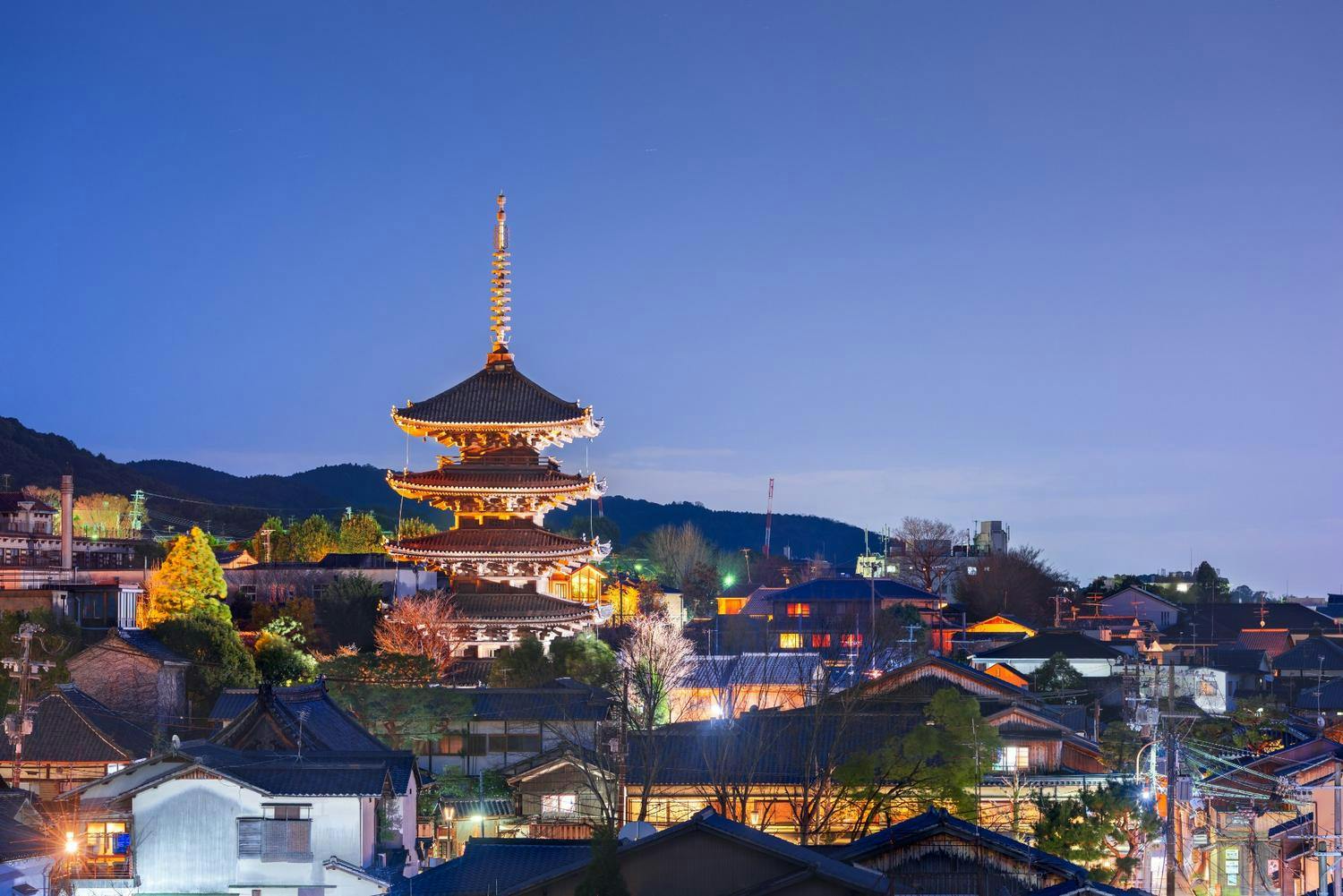 A nighttime scene of Kyoto featuring a beautifully lit pagoda.