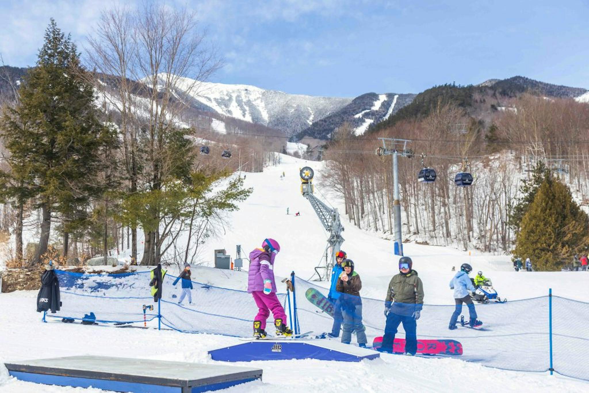 A group of skiers and snowboarders enjoying a day on the slopes at Whiteface Mountain ski resort.