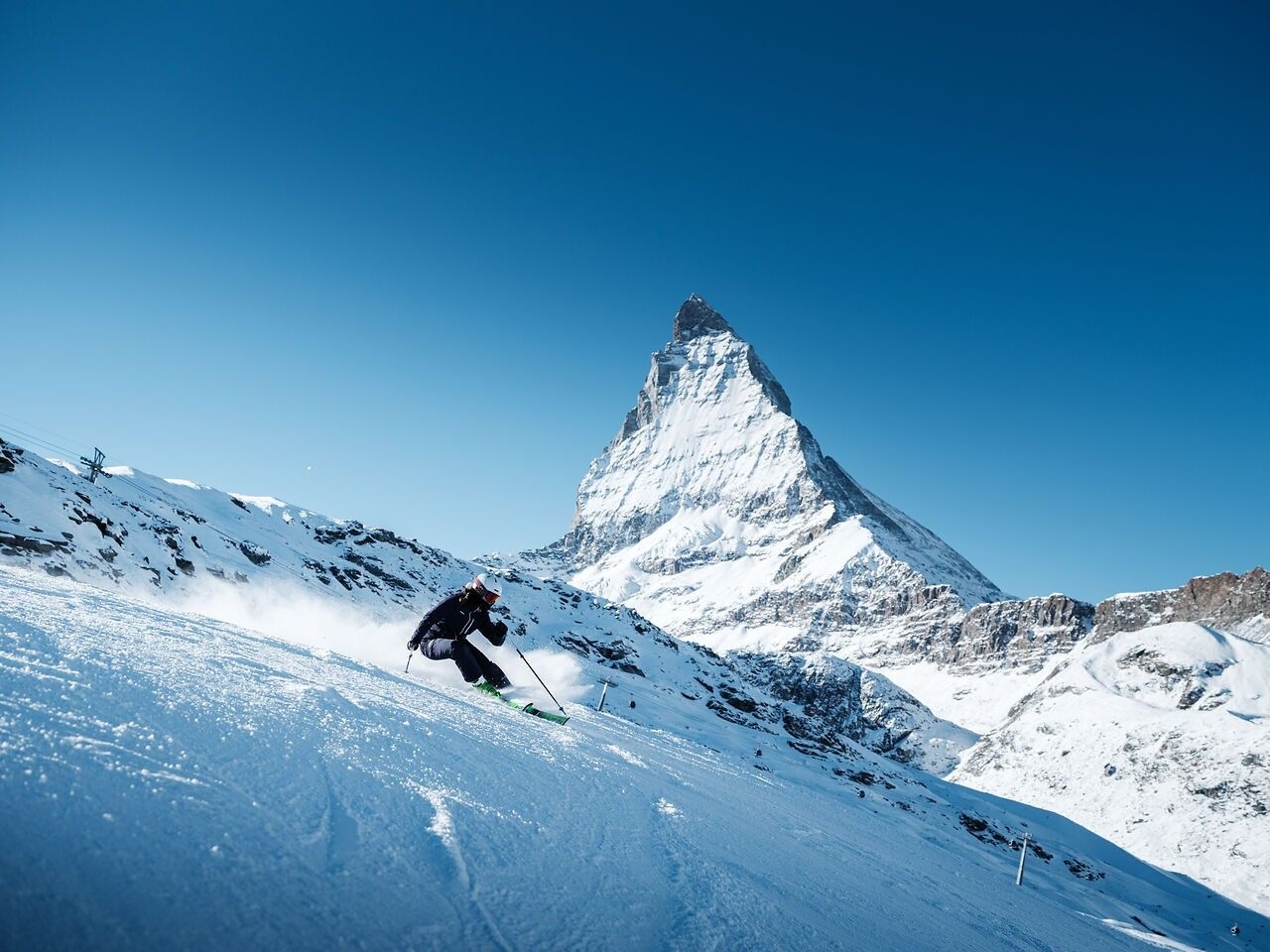 Skier skiing Zermatt on a bluebird day