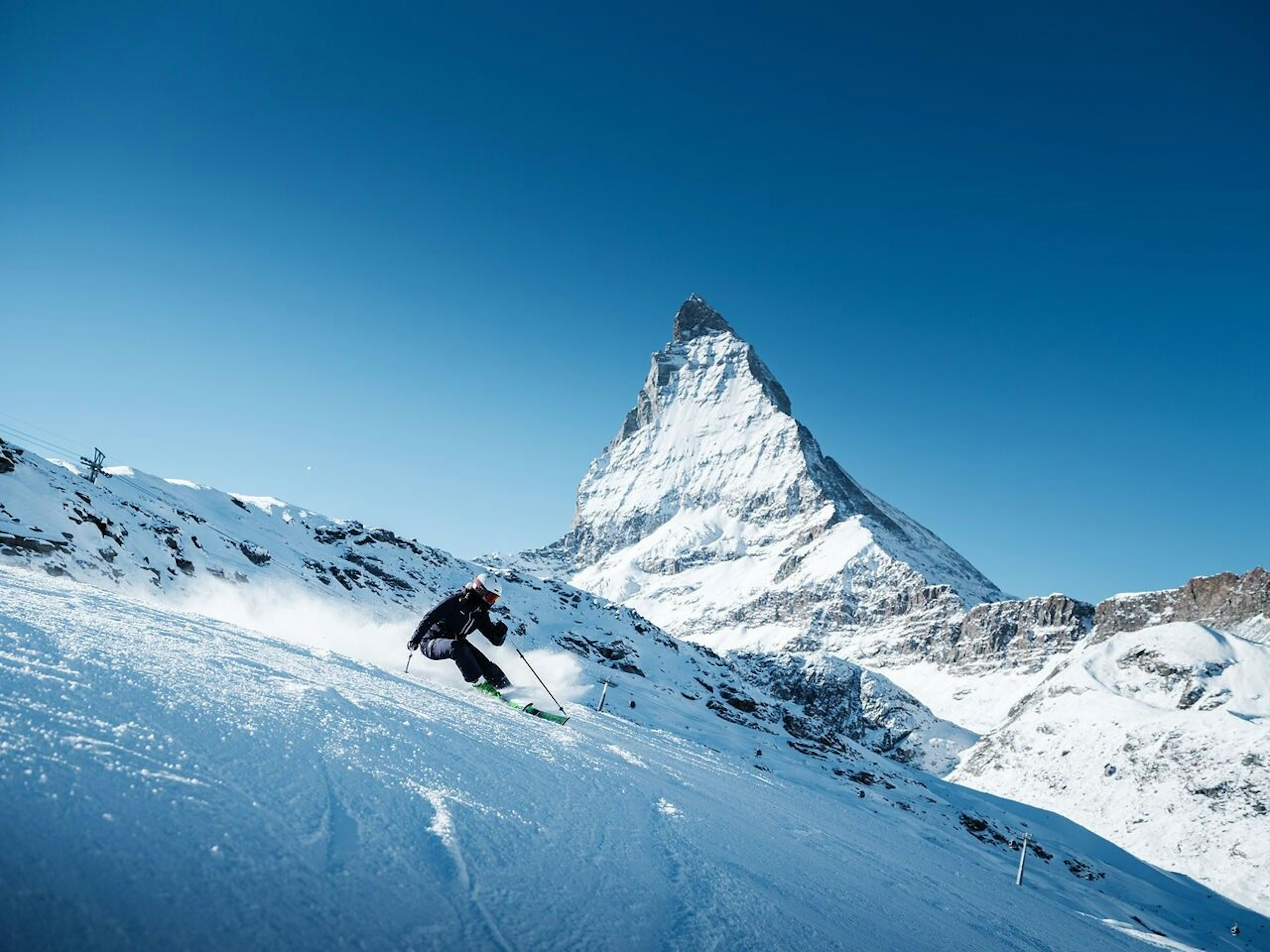 Skier skiing Zermatt on a bluebird day