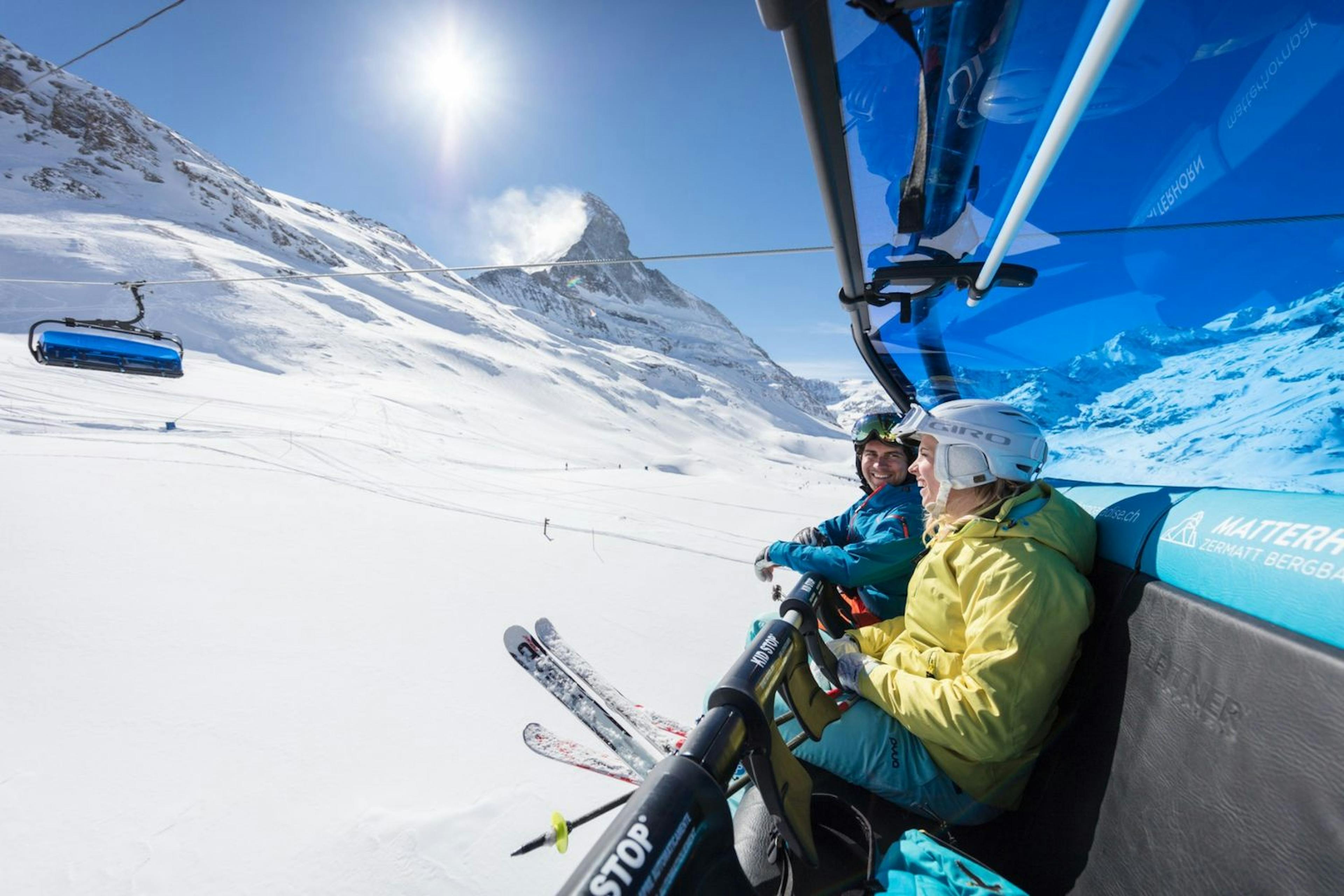 Two skiers riding the chair lift at Zermatt