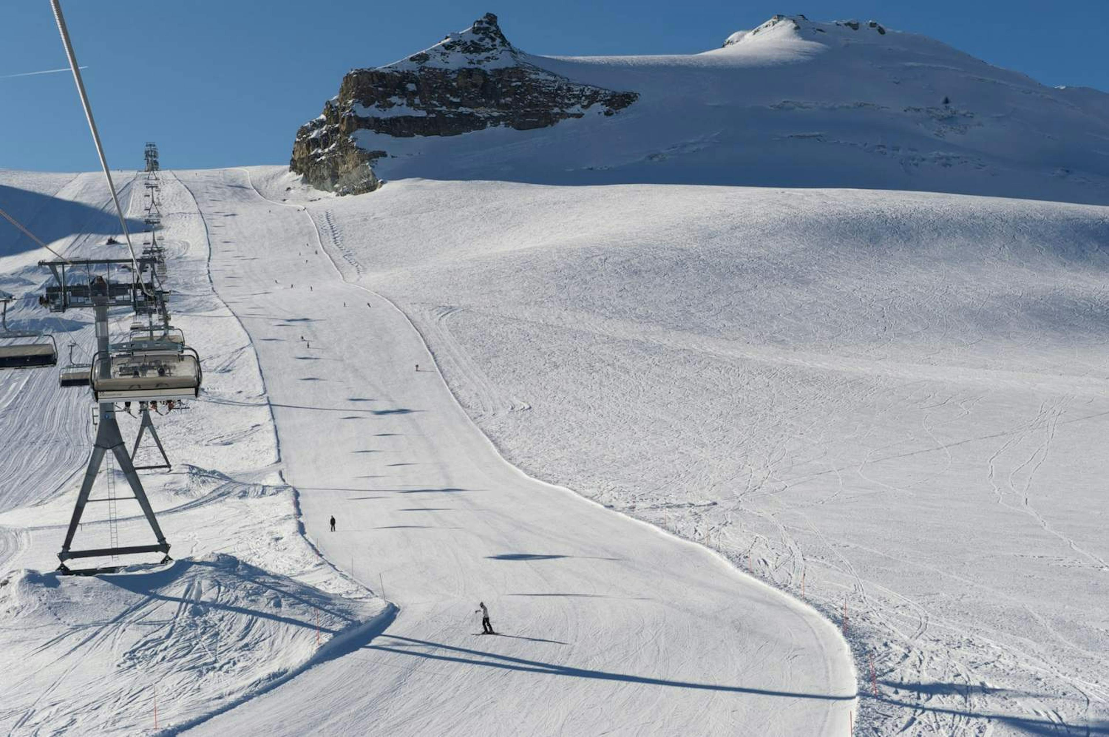 A skier on a groomed run next to the lift at Zermatt