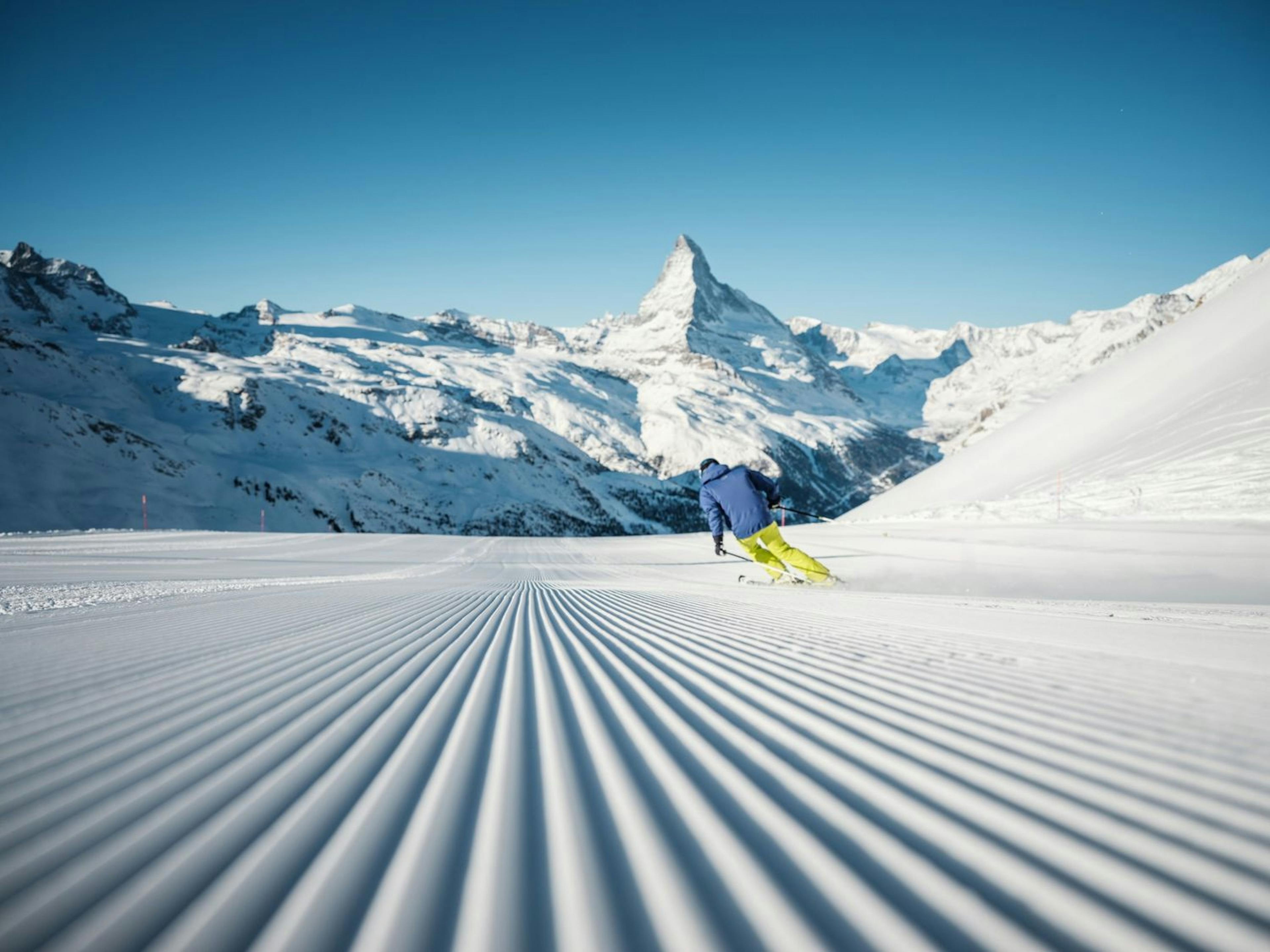 A skier skiing the corduroy at Zermatt