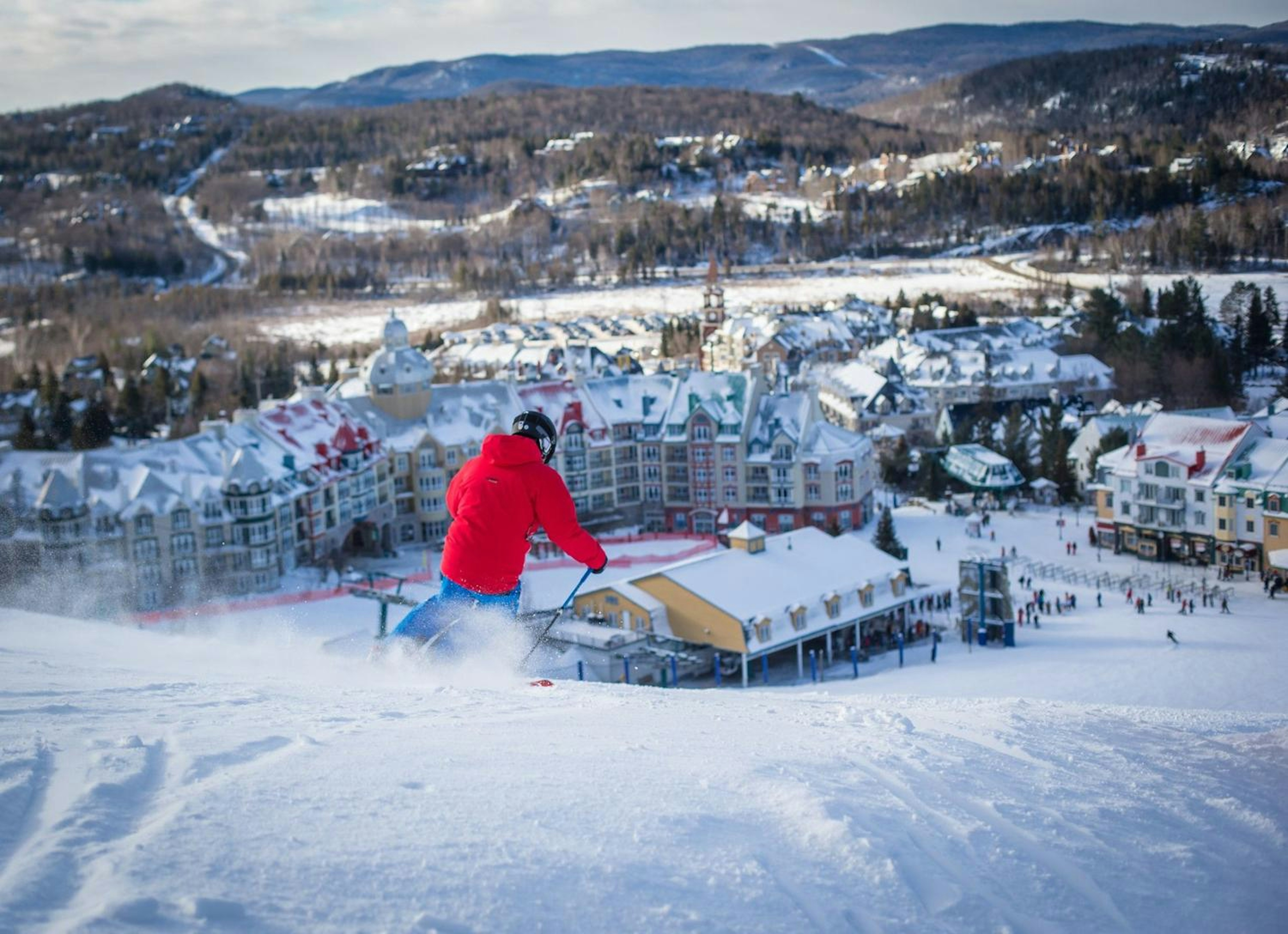 Skier skiing down to Mont Tremblant village