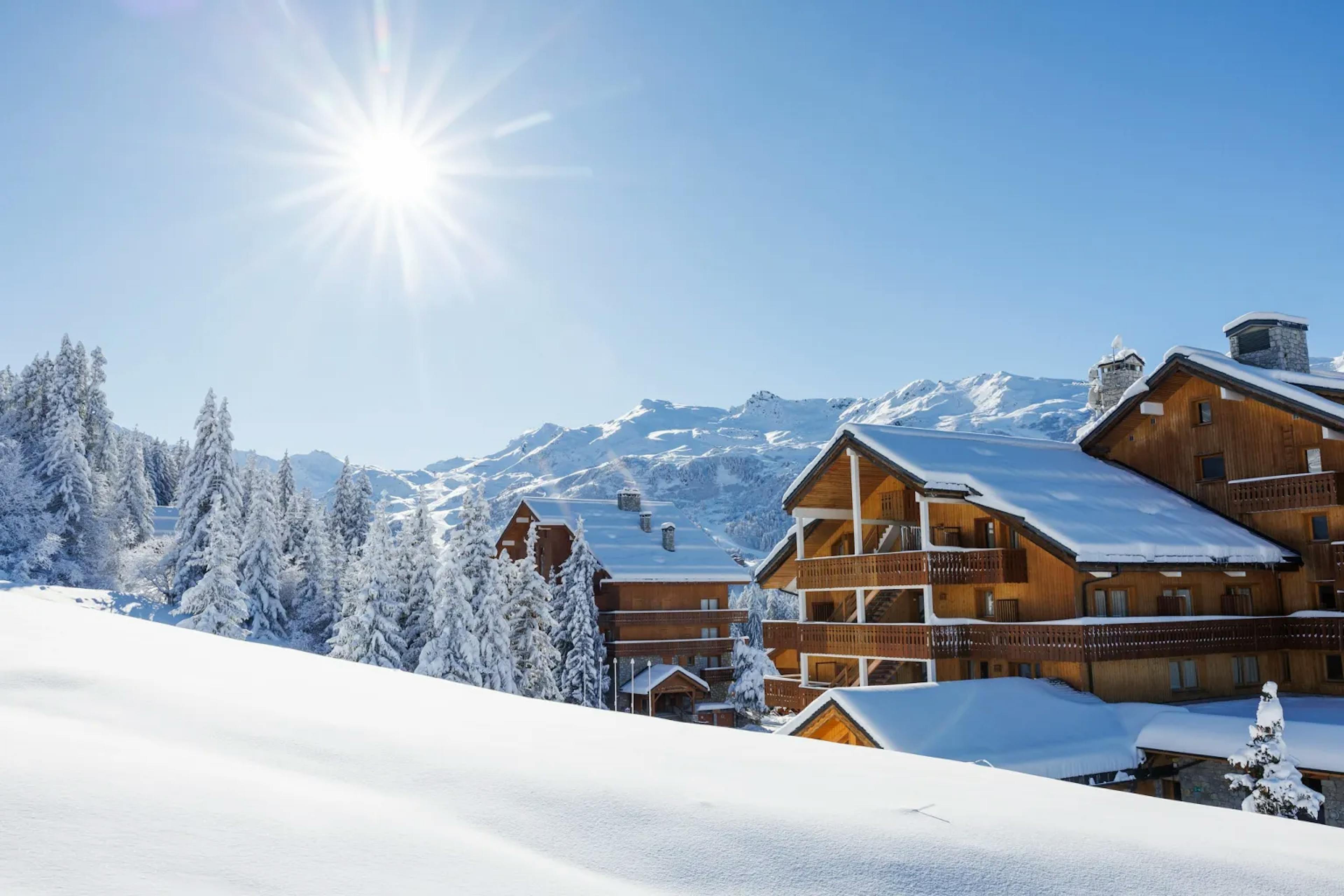 Mountain resort and snowy peaks on the background.