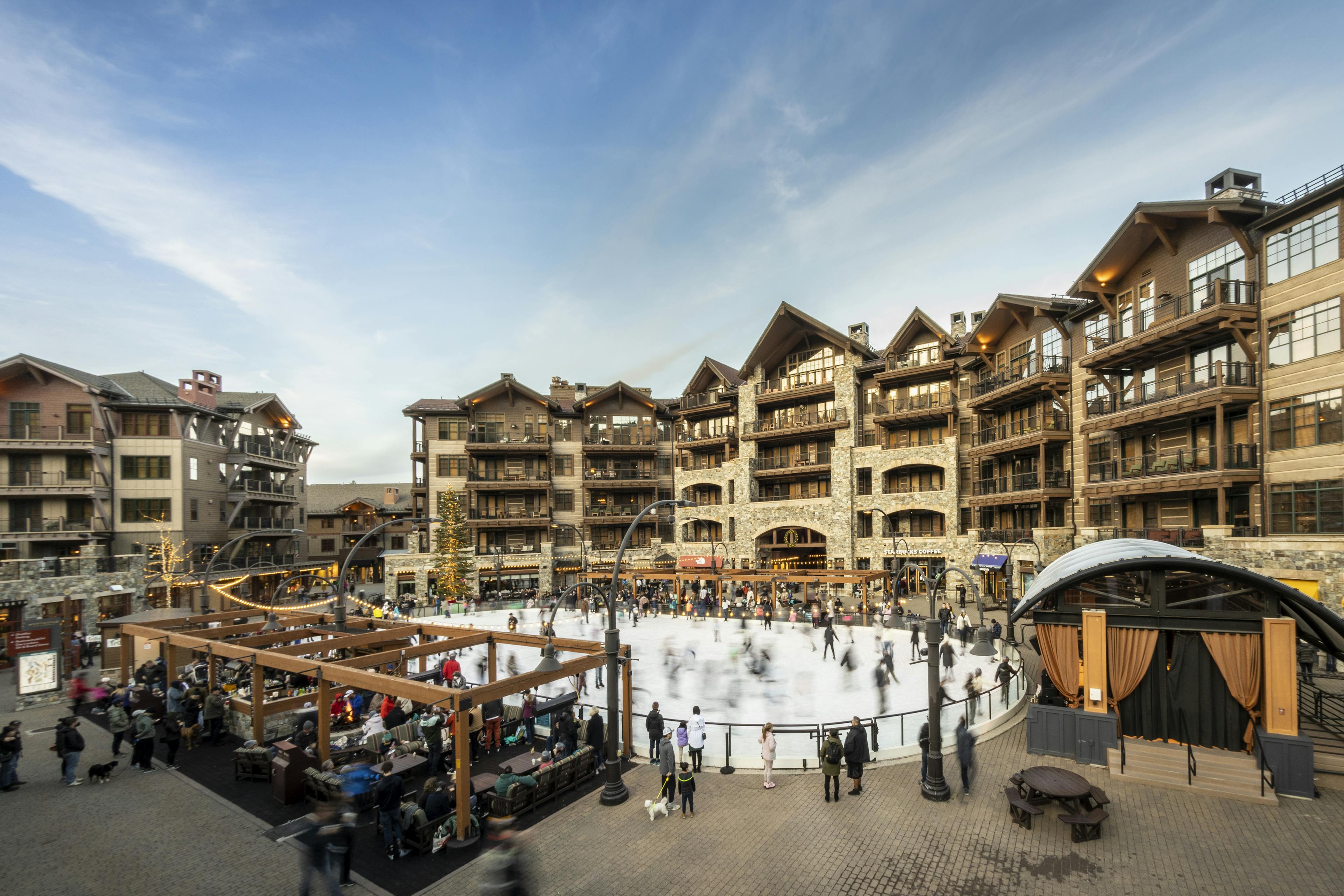 Northstar at Tahoe ice skating rink and village filled with people on a blue bird day