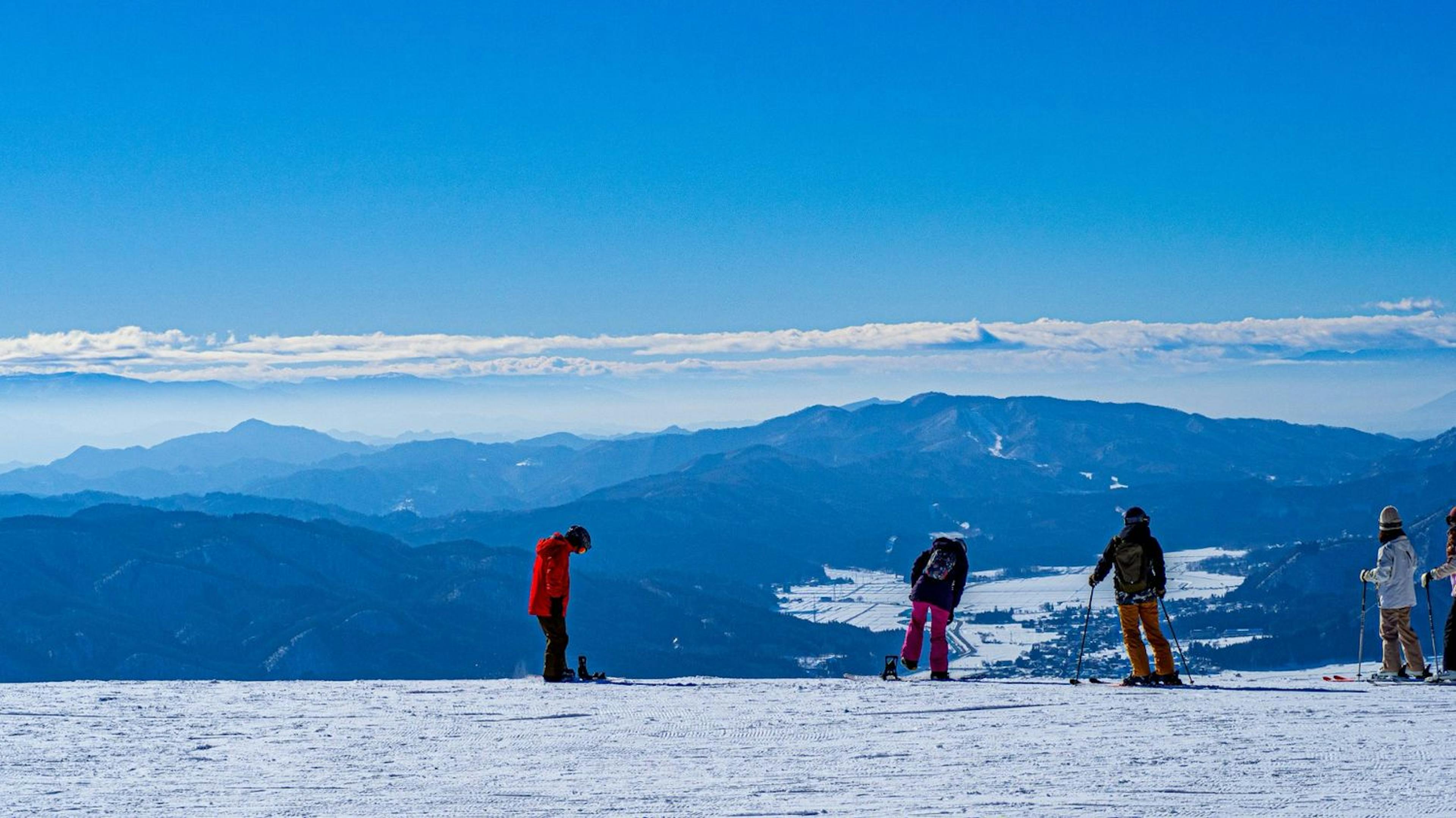 Friends gather on a snowy mountain in Hakuba