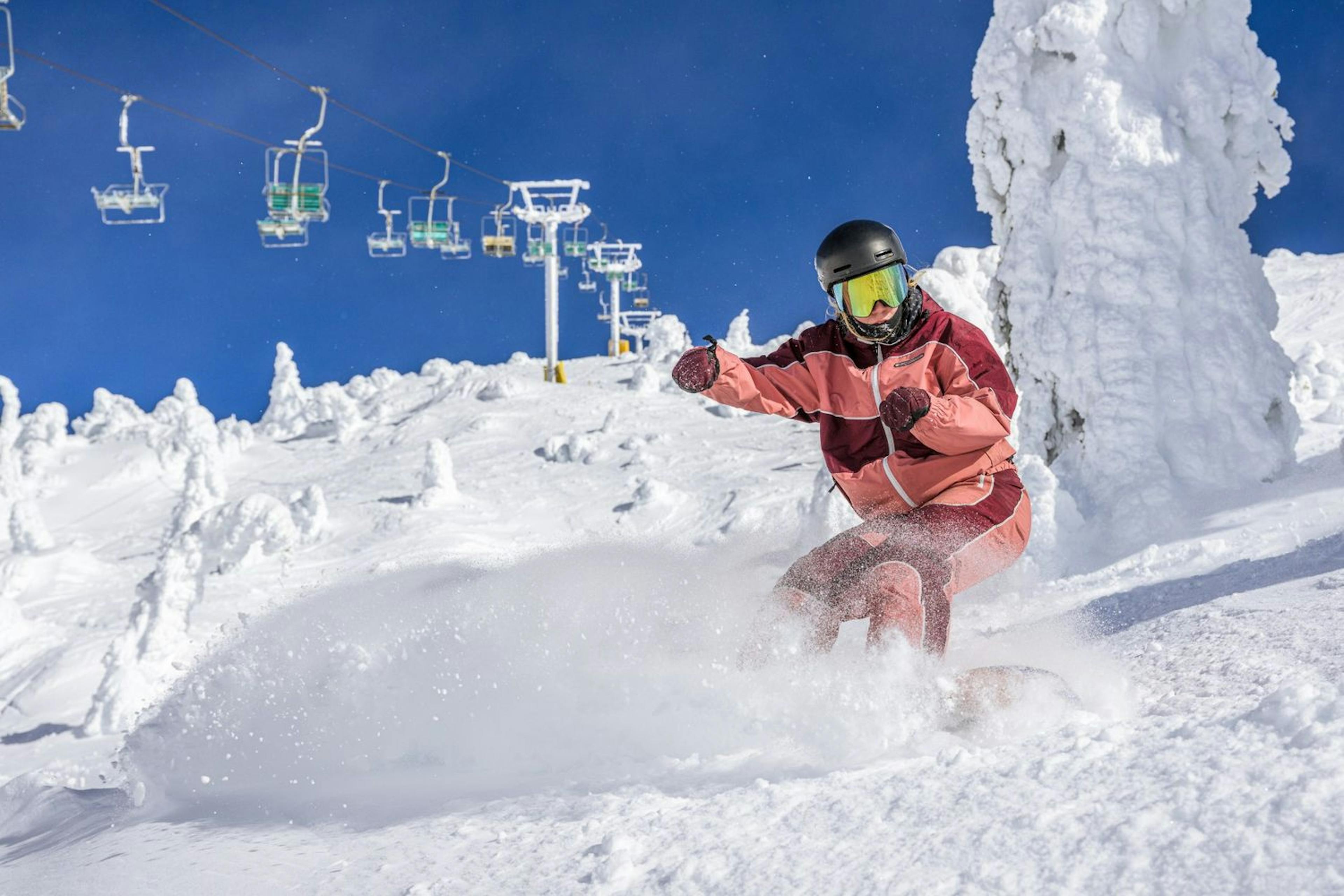 A snowboarder descends a snowy slope at Big White Ski Resort