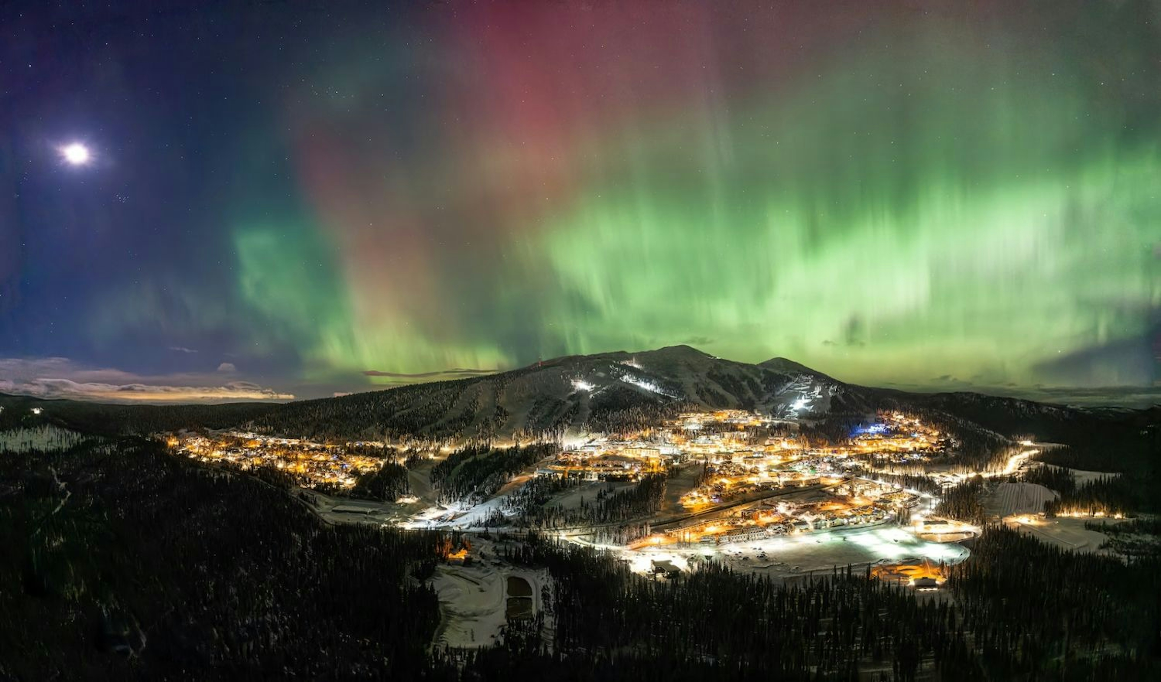 The aurora borealis illuminates the sky above Big White Ski Resort