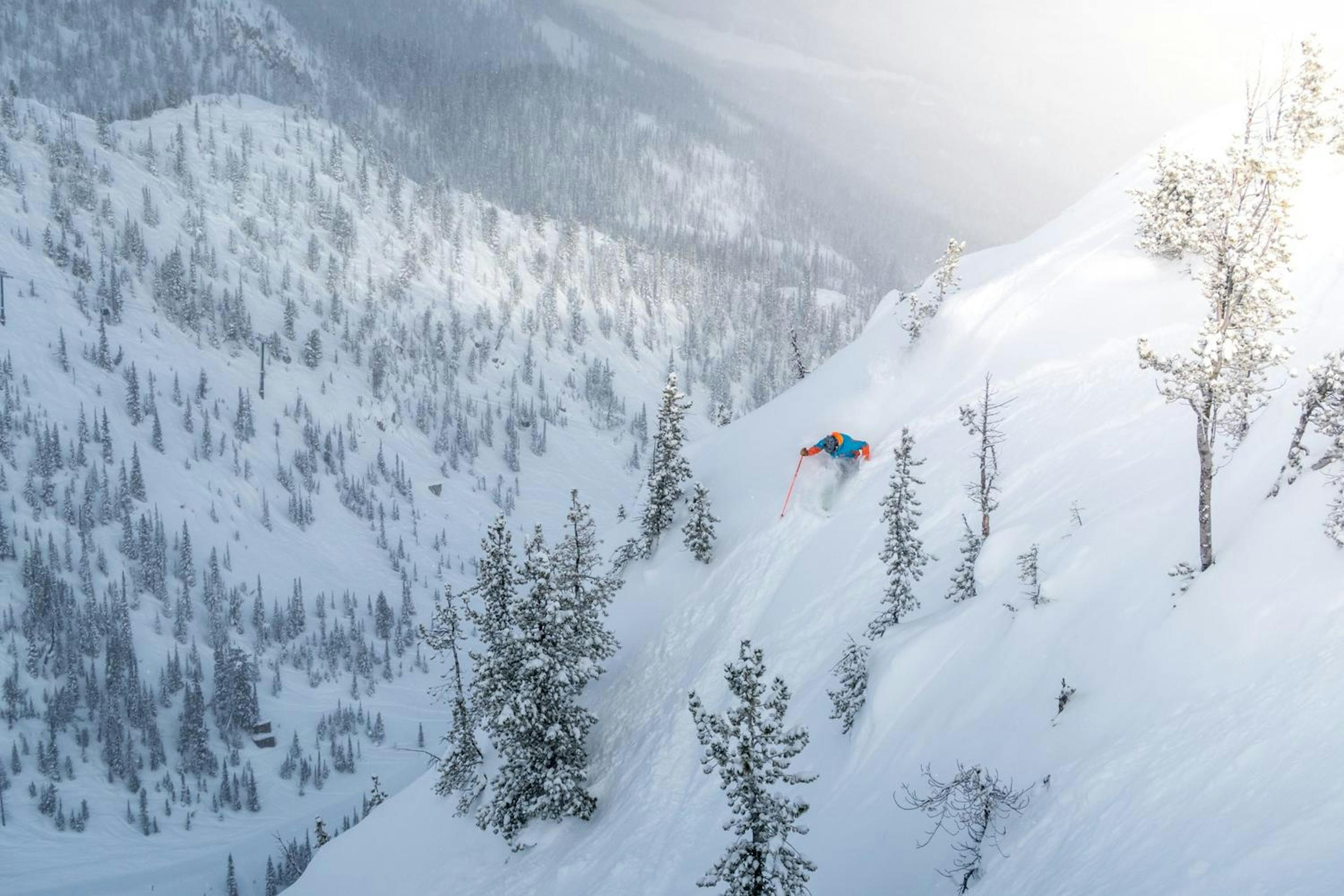 A skier navigates a steep descent at Kicking Horse