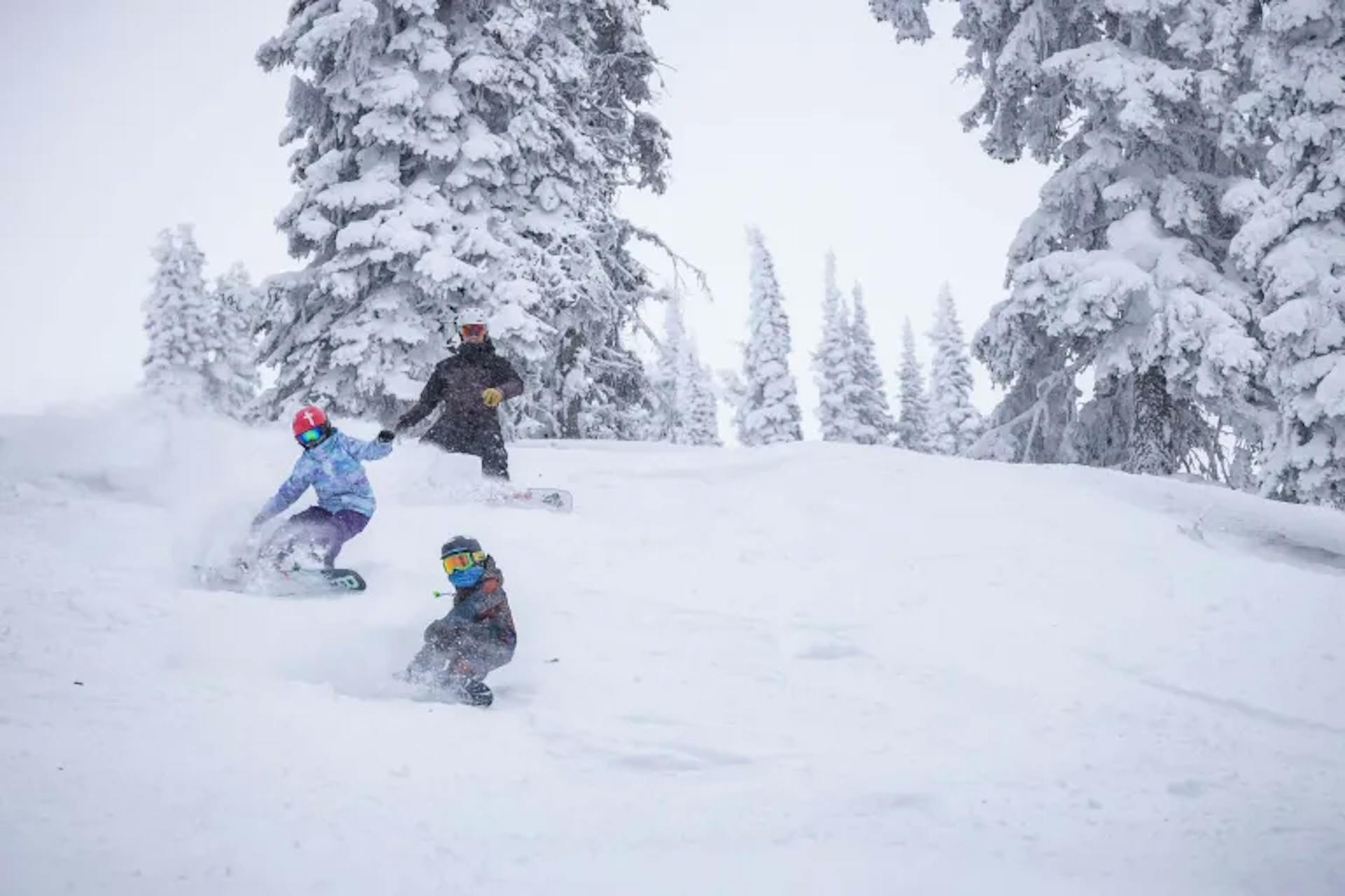 Family snowboarding together at Revelstoke