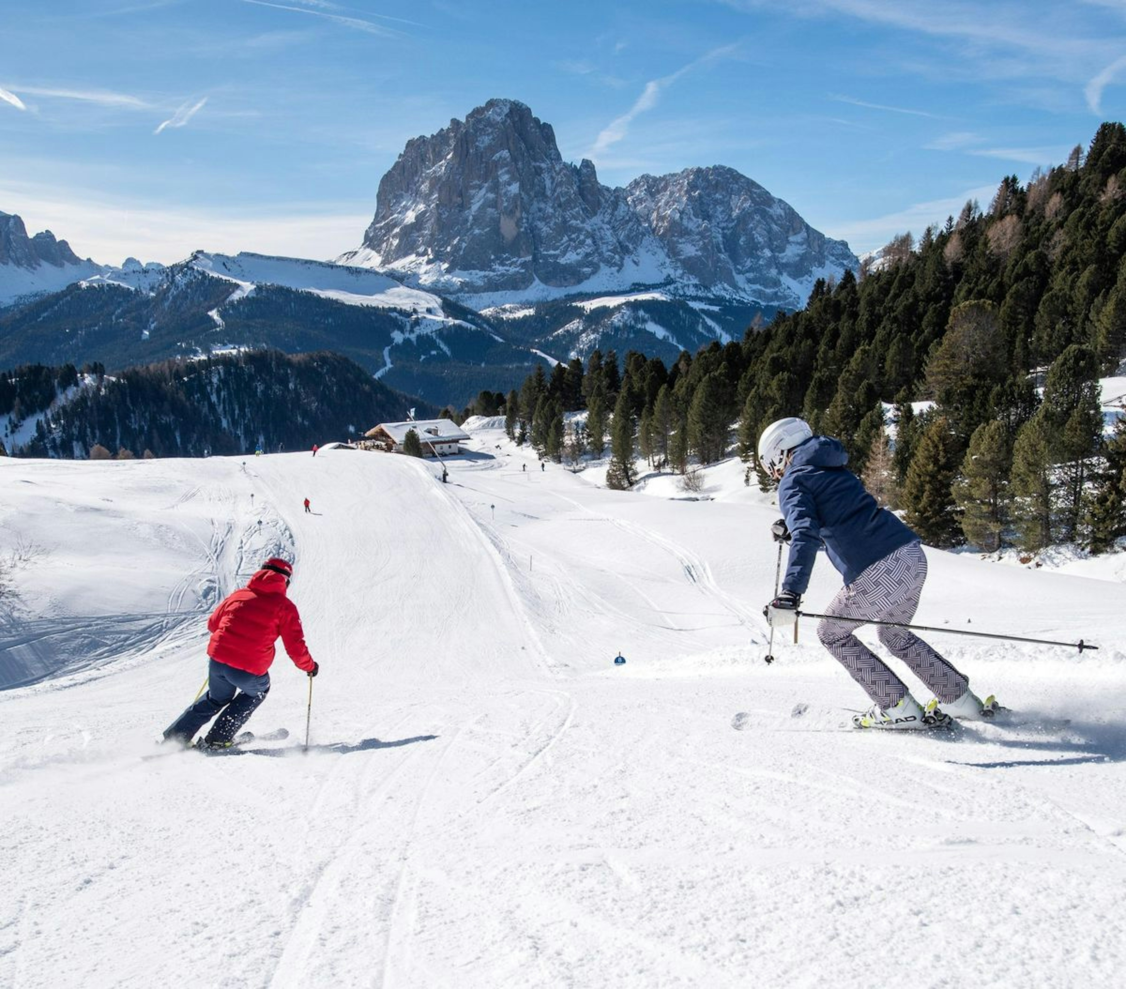 Two skiers skiing the slopes at Val Gardena