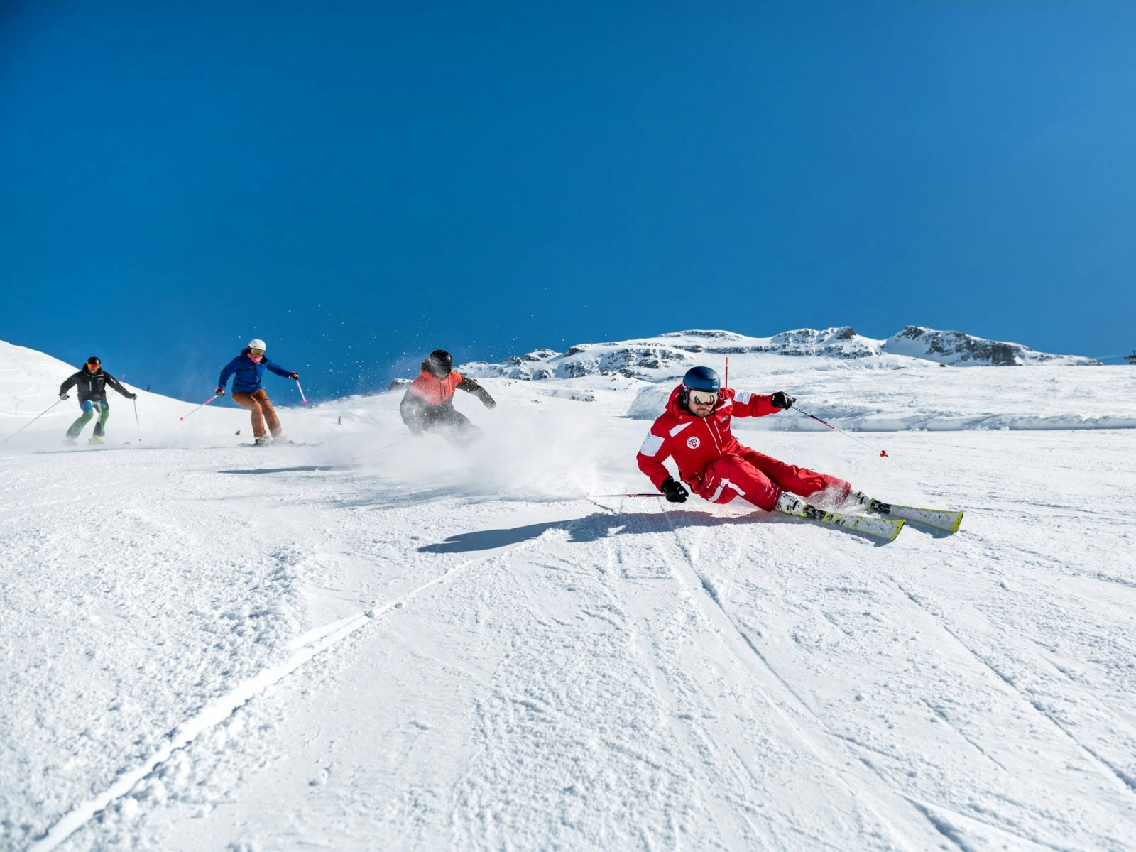 Four skiers hitting the fresh powder at Engelberg-Titlis