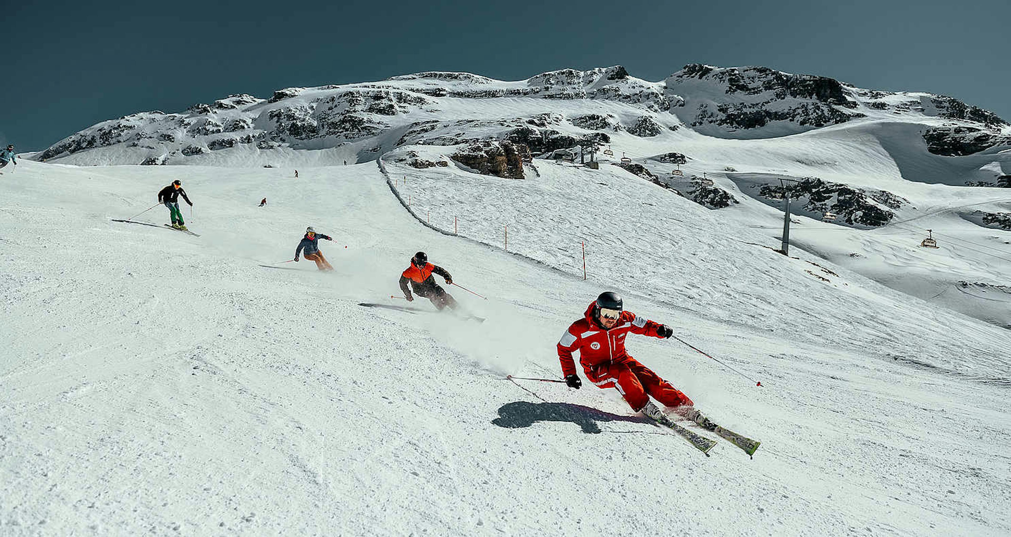 Four skiers skiing down Mt. Titlis near Engelberg