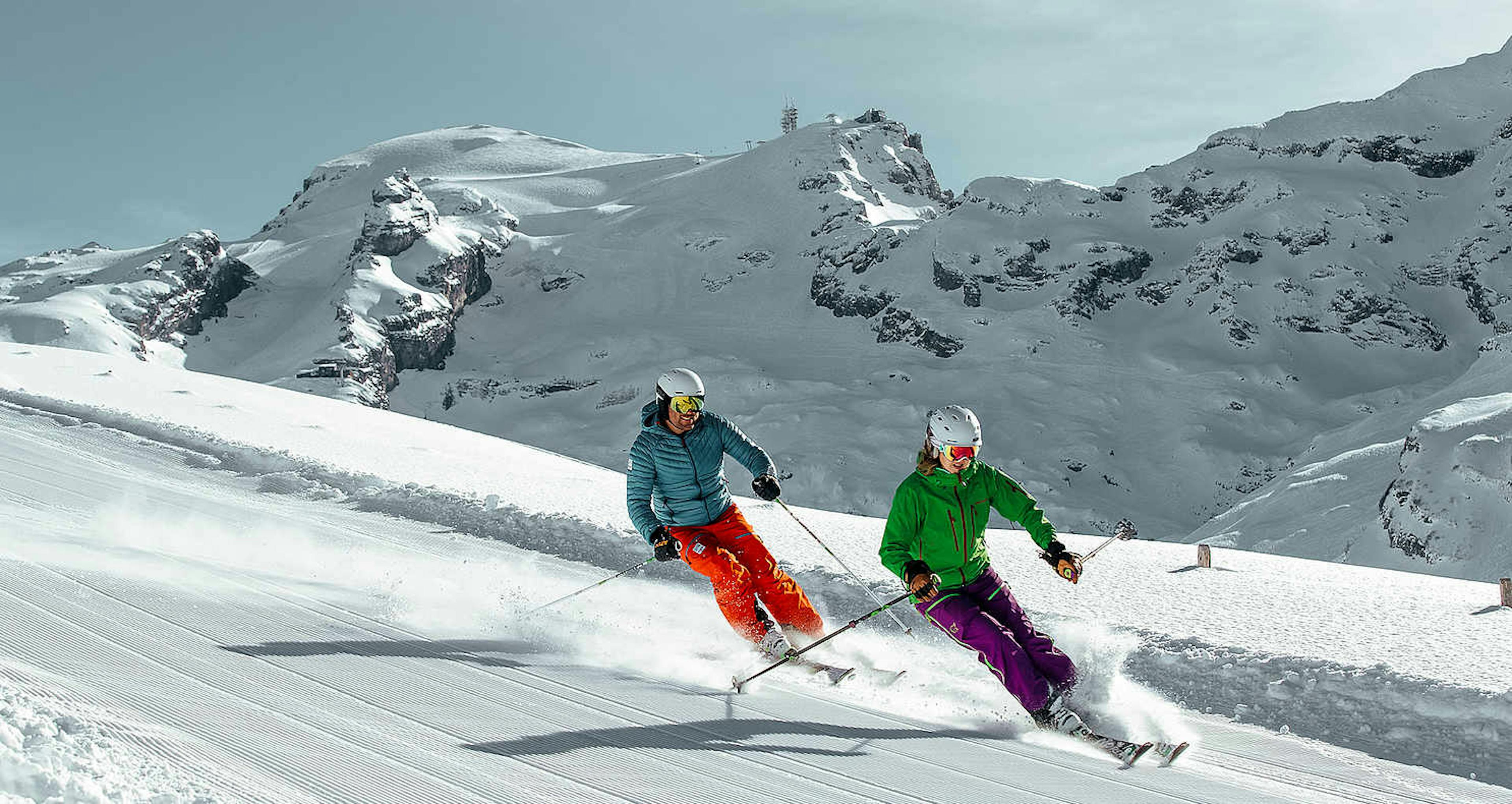 Two skiers skiing the slopes of Mt. Titlis near Engelberg