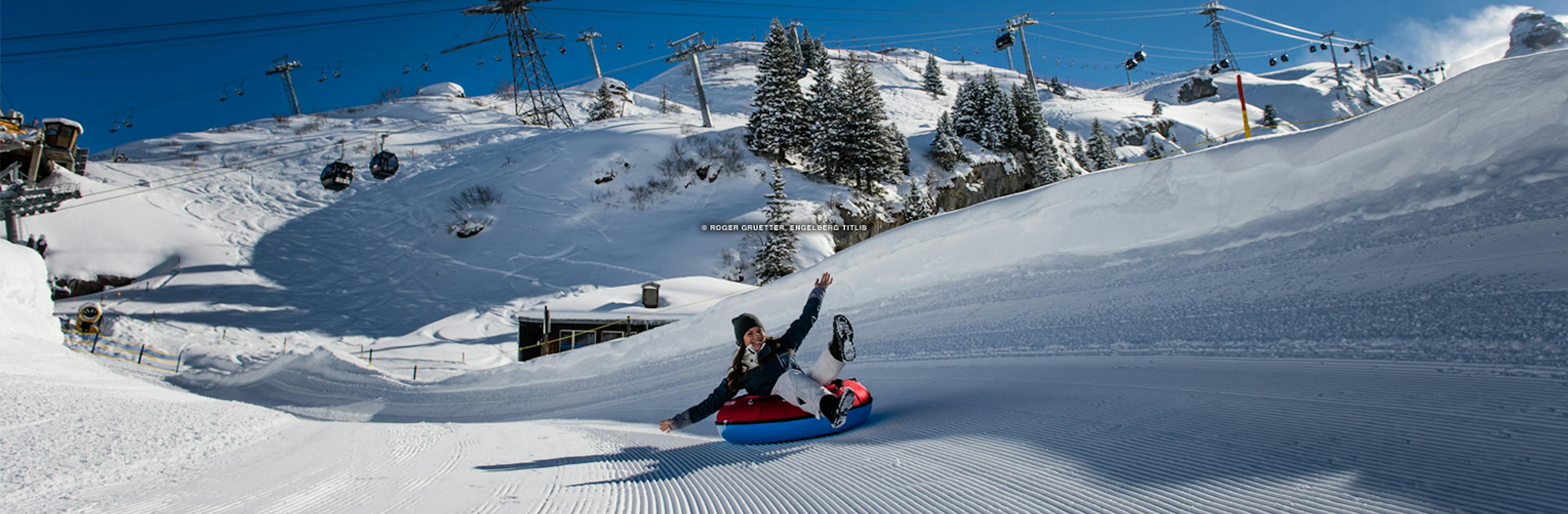 A woman tubing down the slopes at Mt. Titlis near Engelberg