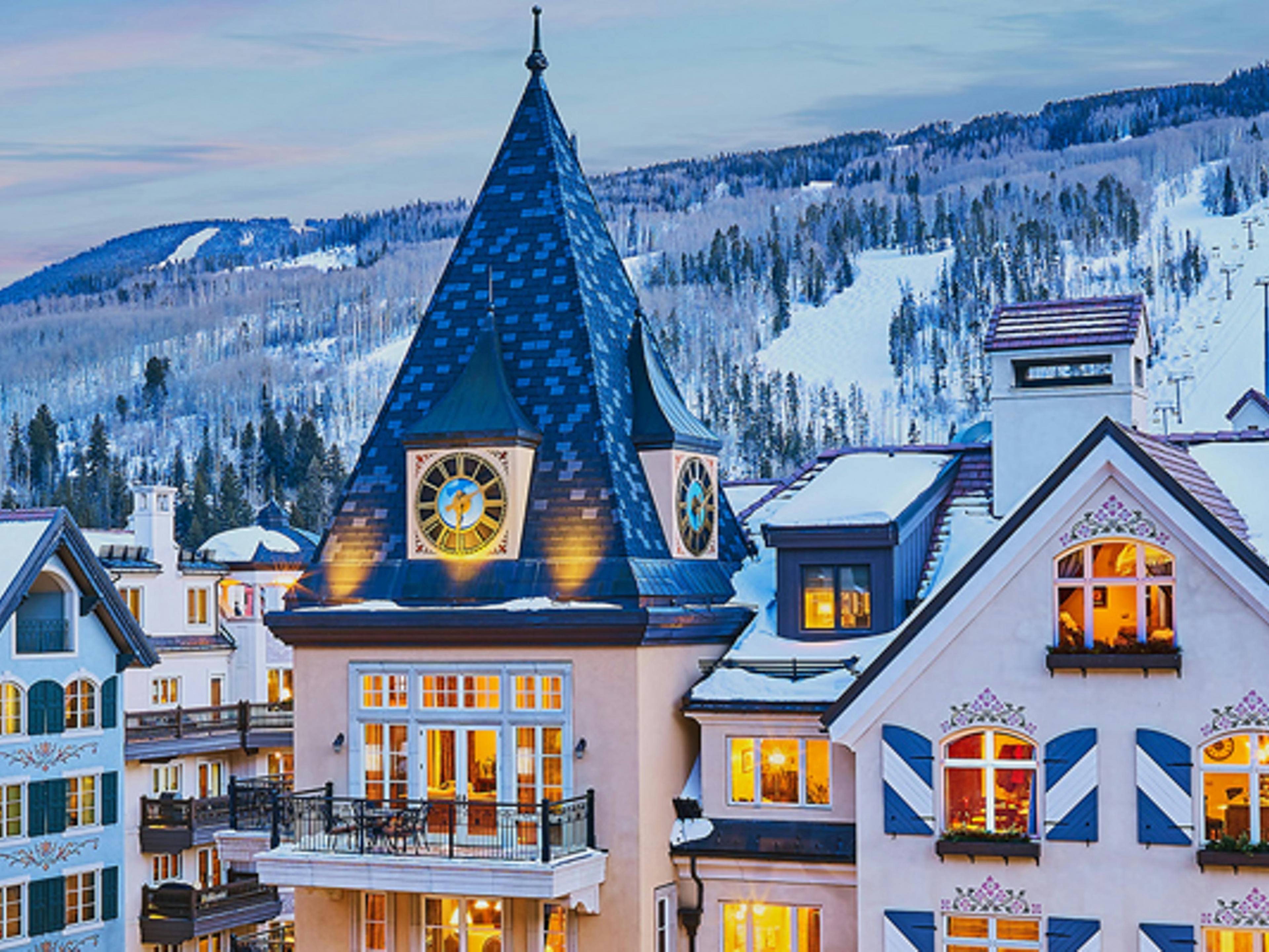 A scenic view of a hotel with a clock tower in Vail