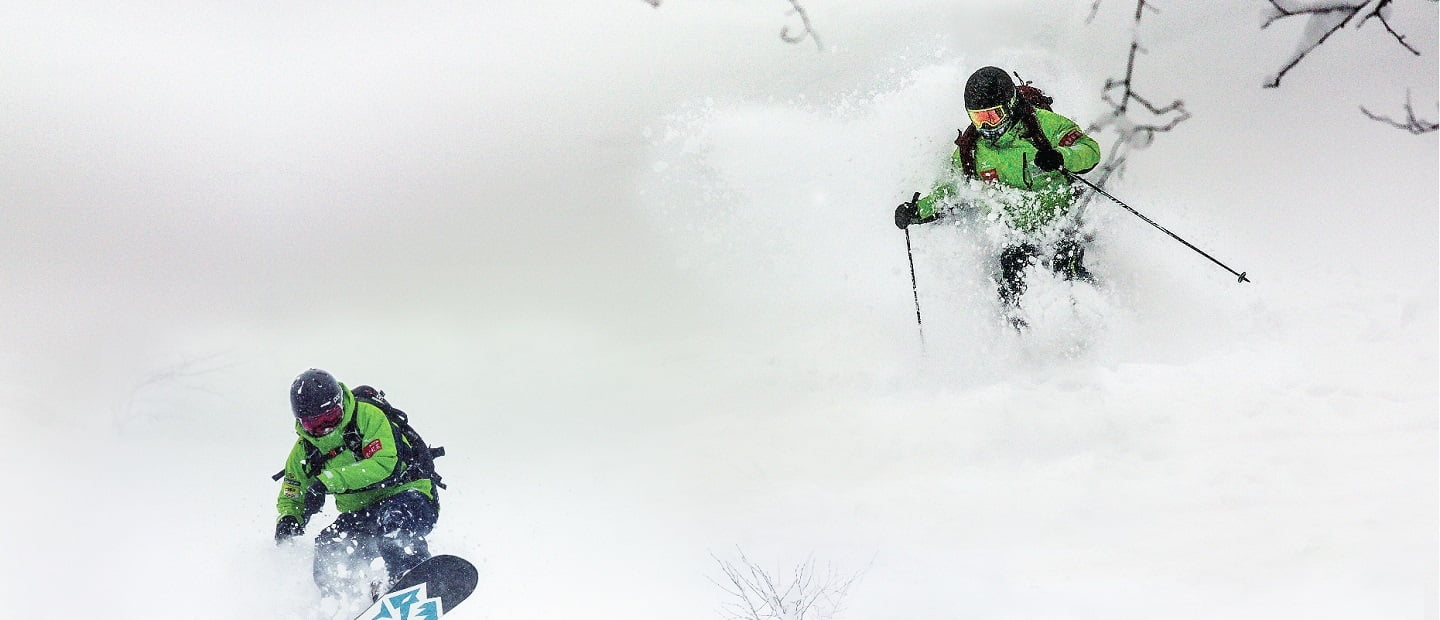 Two skiers skiing the slopes at Rusutsu Ski Resort