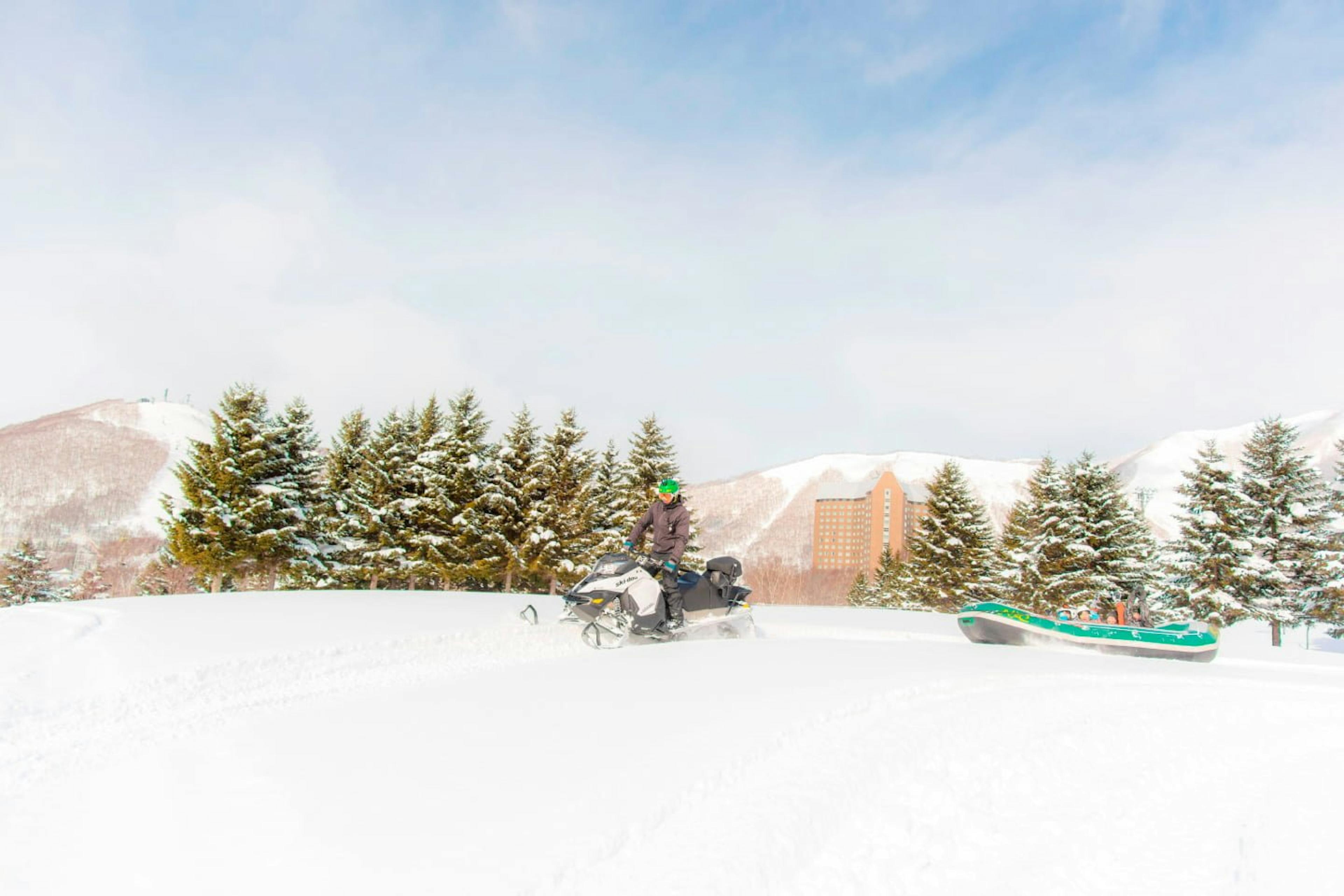 A family enjoying snow rafting at Rusutsu Ski Resort