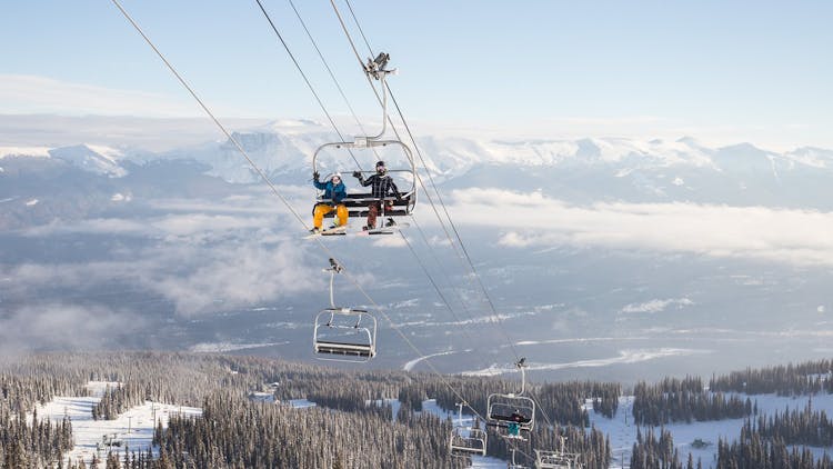 Two skiers riding the chairlift at Marmot Basin