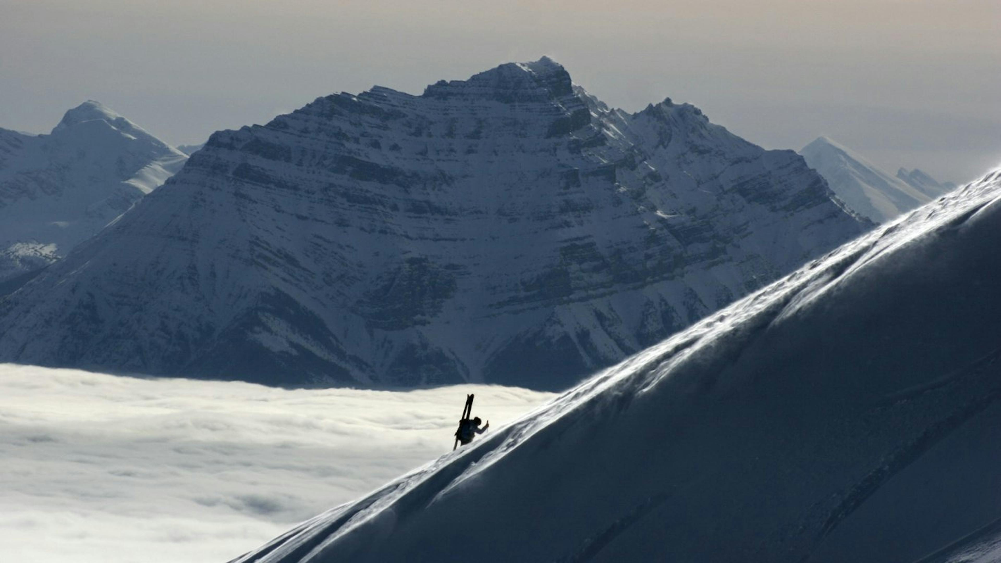 Man partaking in ski touring in Marmot Basin.