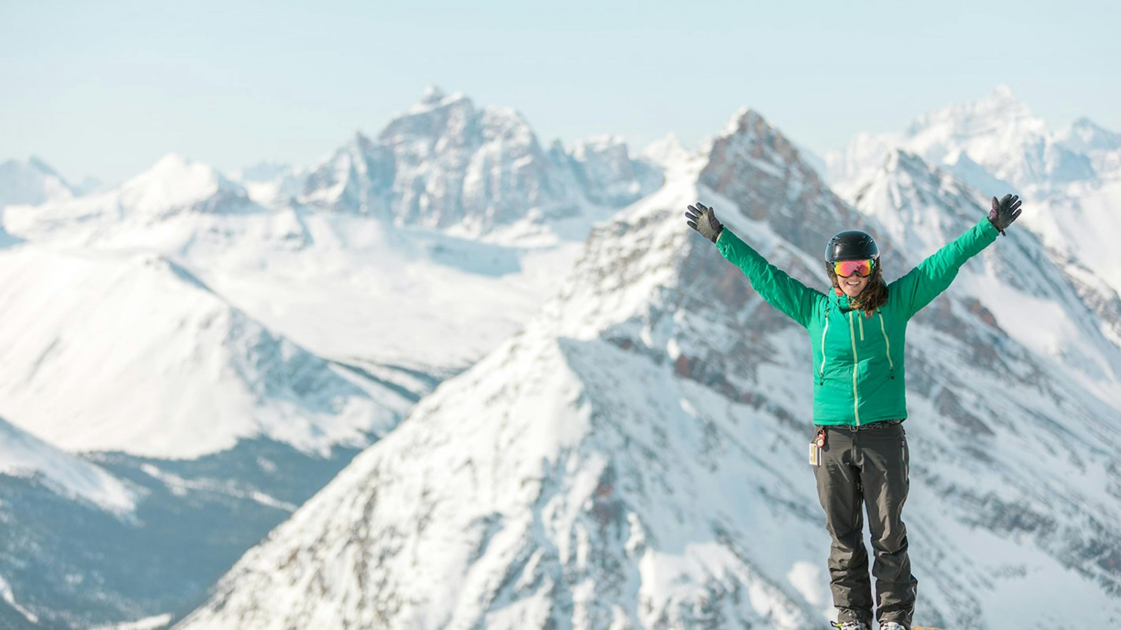 Woman in green jacket taking in the view in Marmot Basin