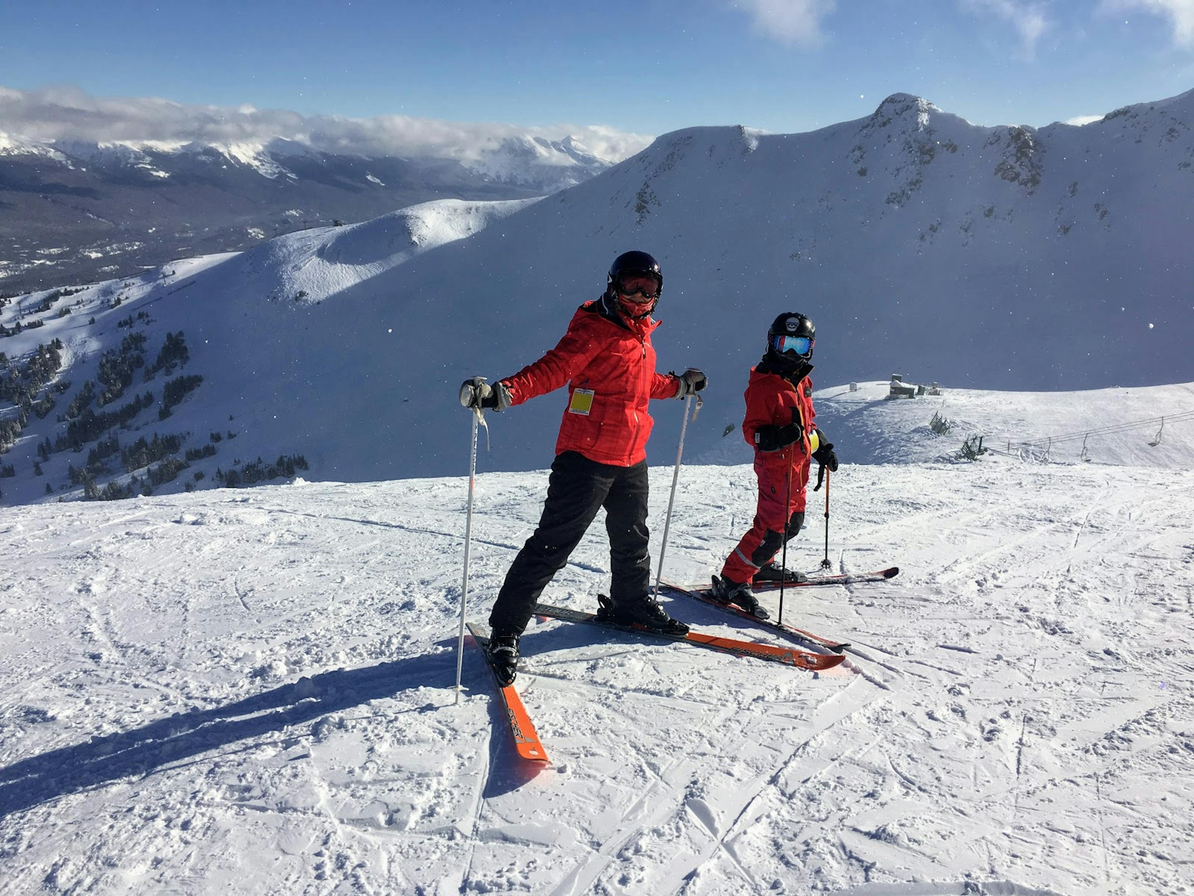 Two skiers skiing the slope at Marmot Basin