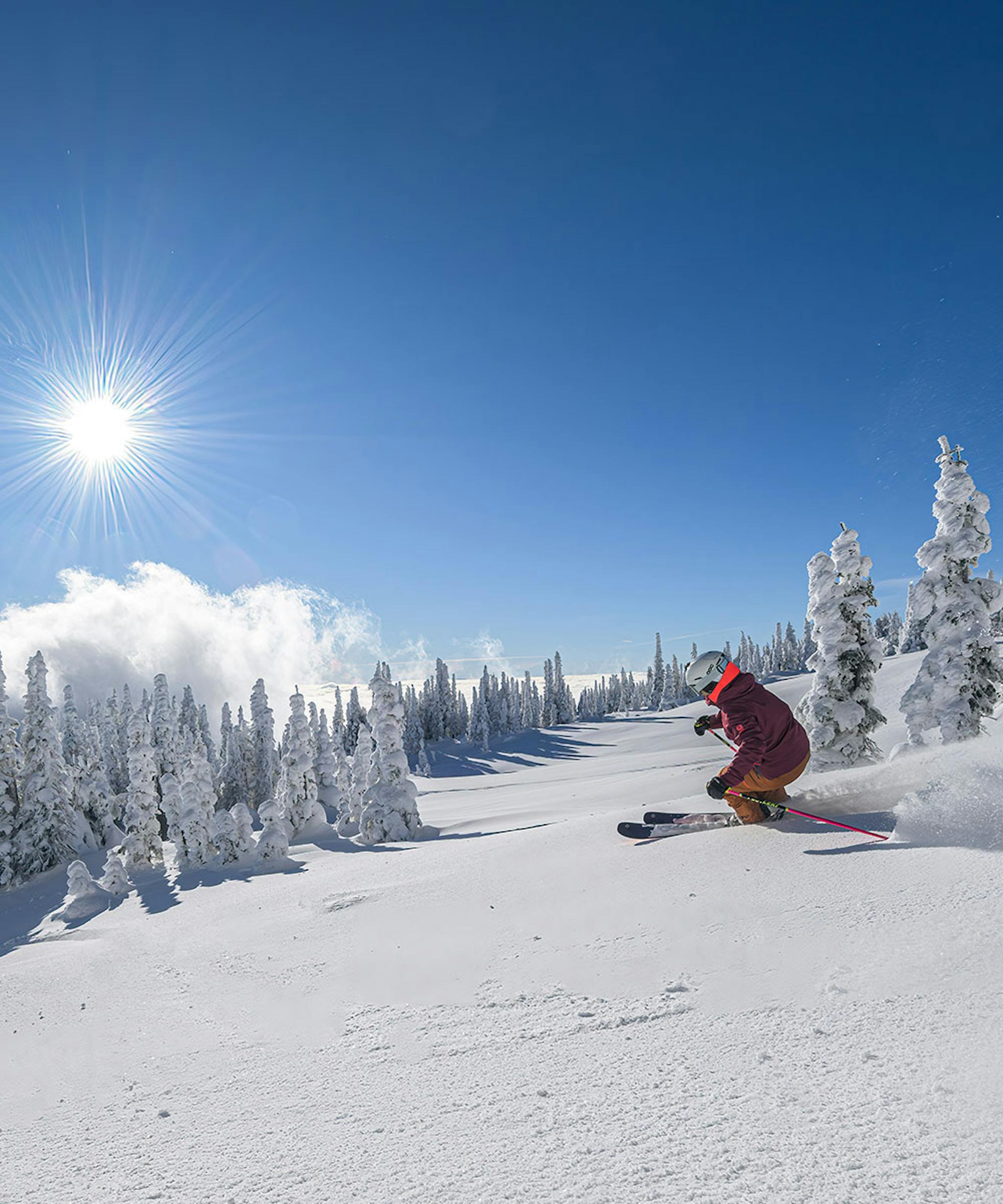 Skier skiing the morning snow in Big White Ski Resort