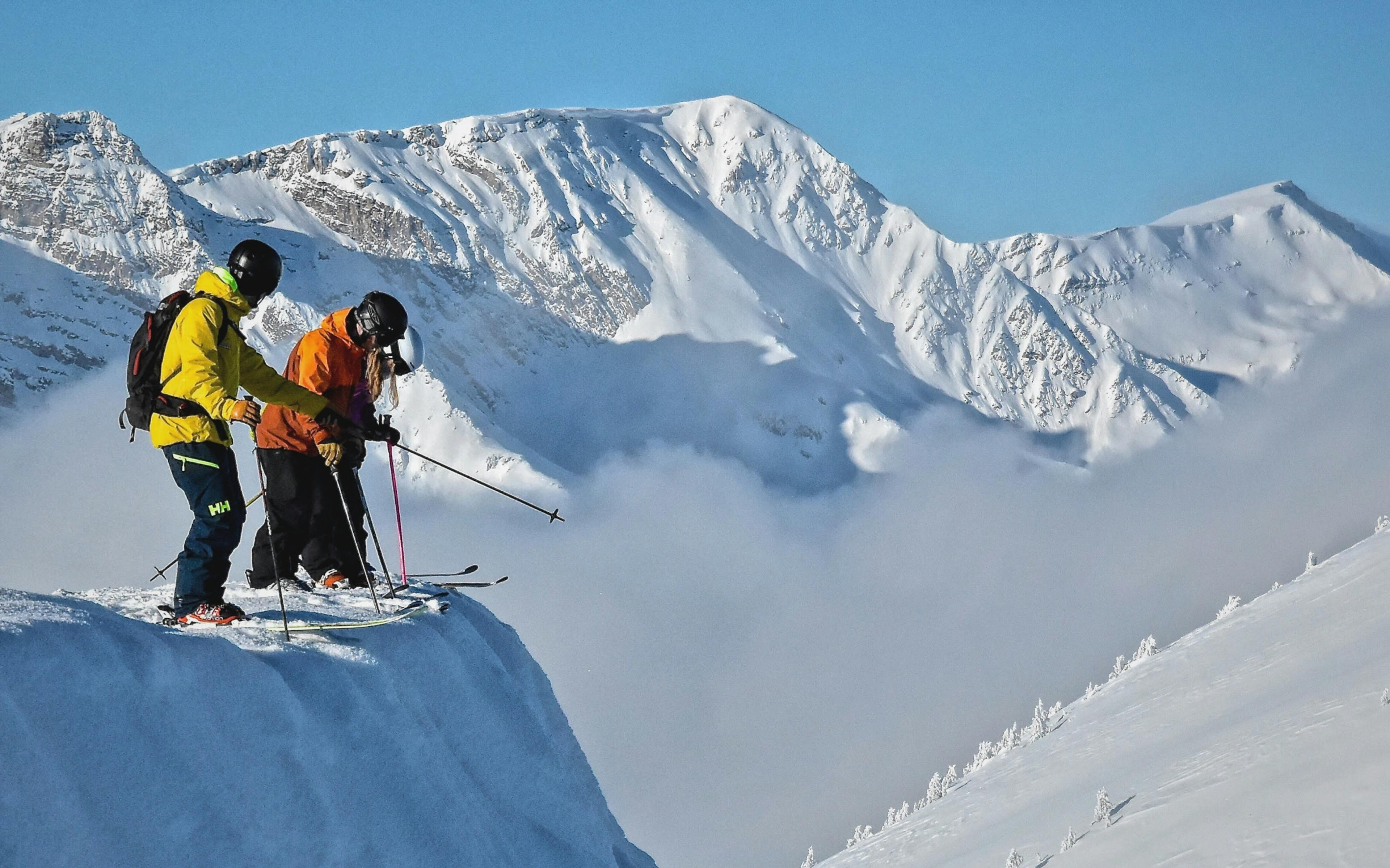 Skiers skiing the morning snow in Kicking Horse Mountain Resort