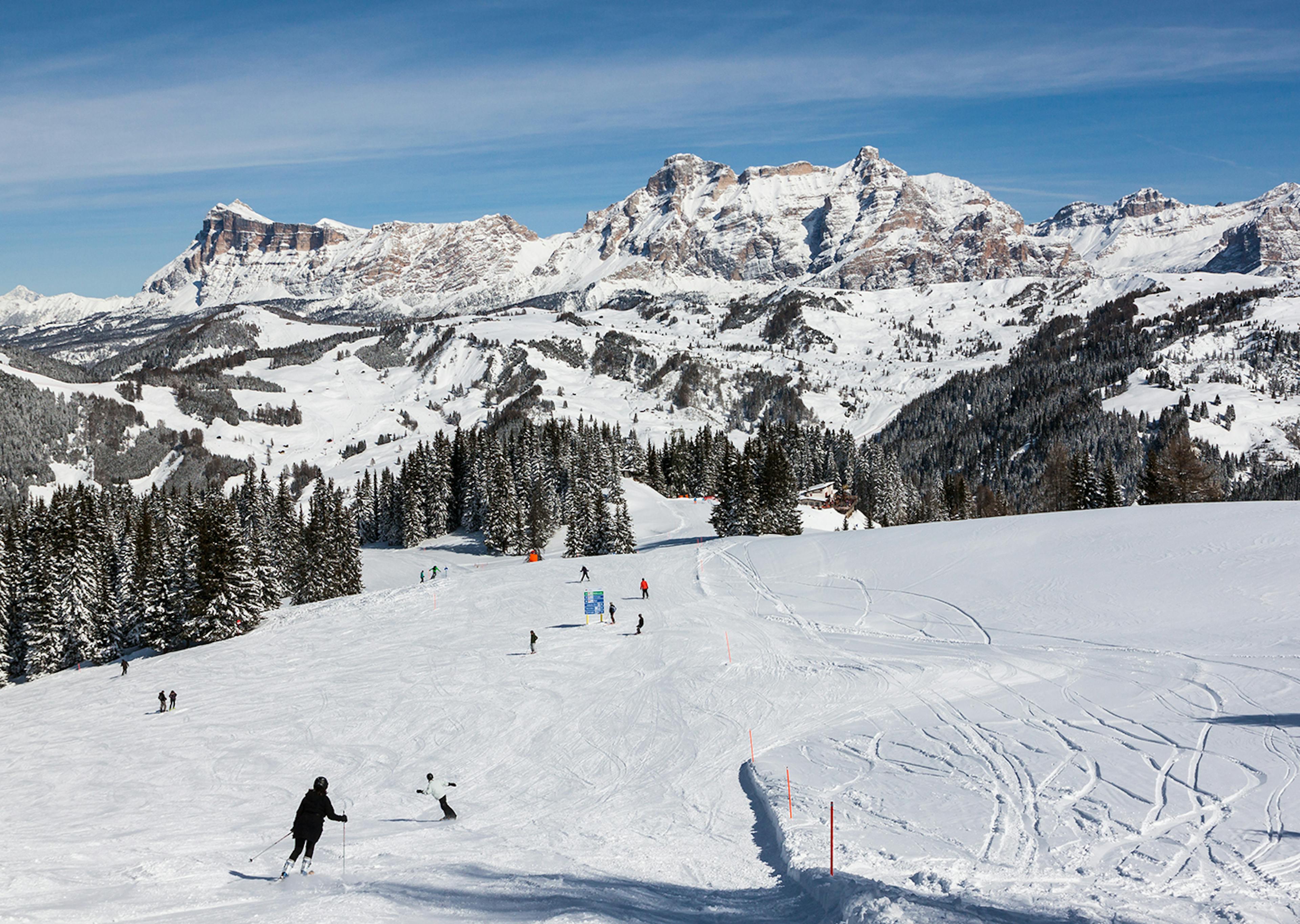 Skiers skiing down Alta Badia in the afternoon