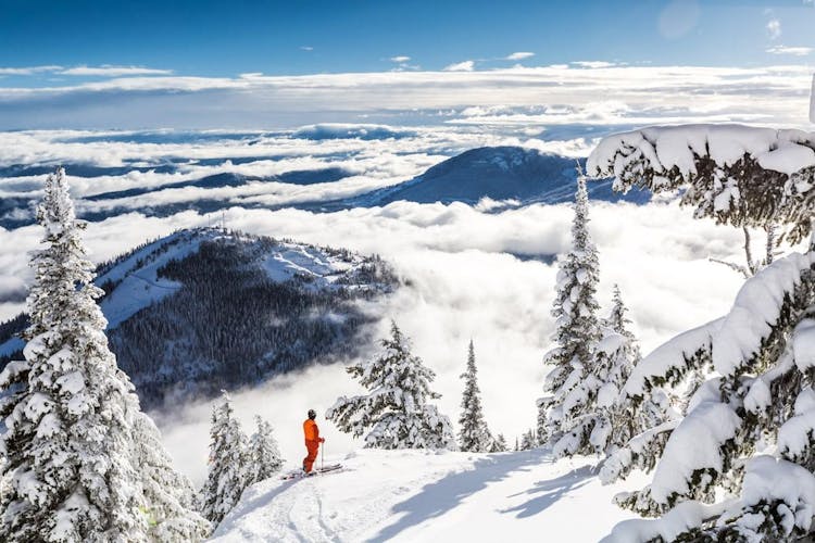 Skier overlooking the scenic views of RED Mountain Resort.