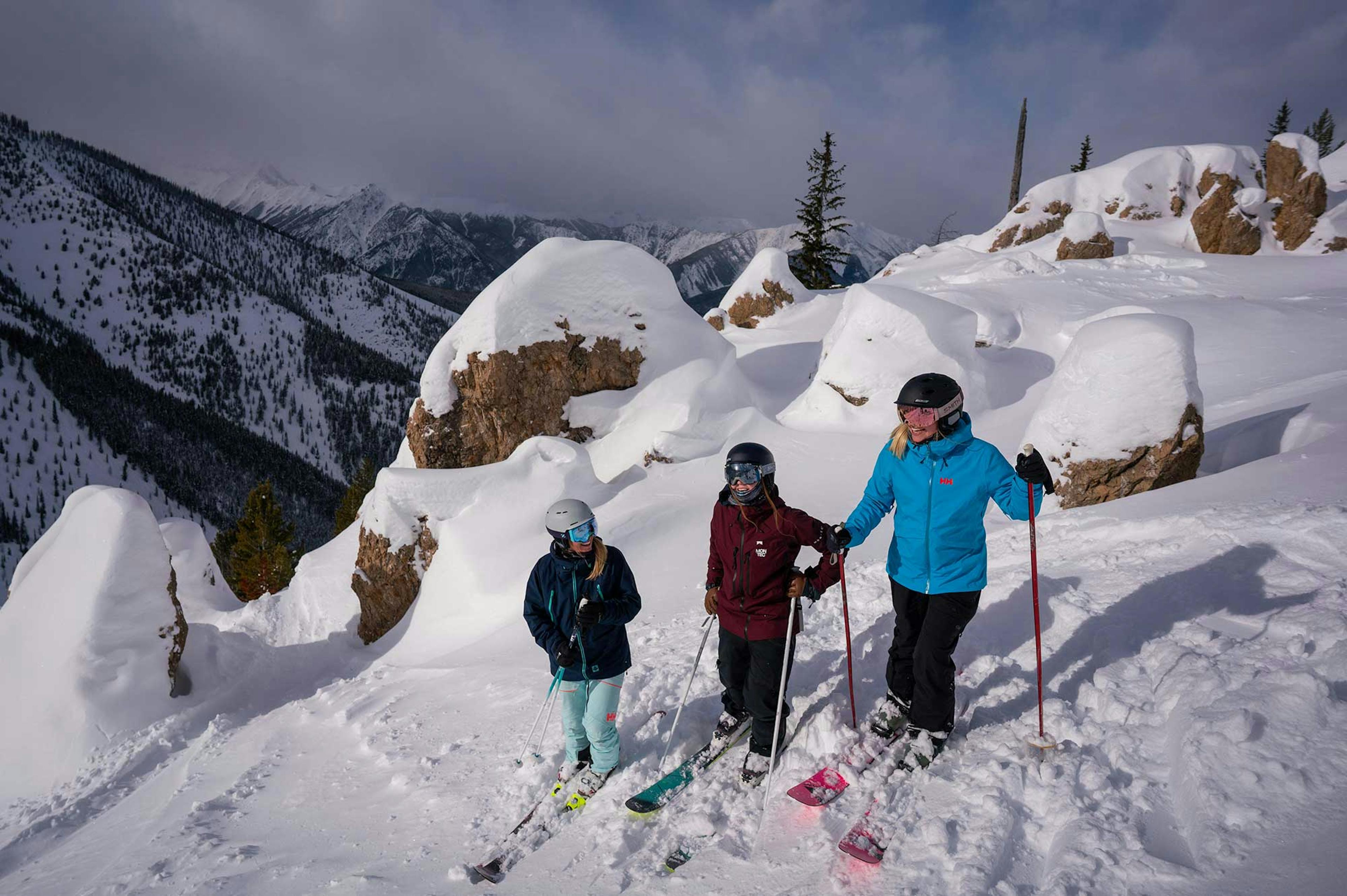 Three skiers taking a break on the slopes of Panorama Mountain Resort