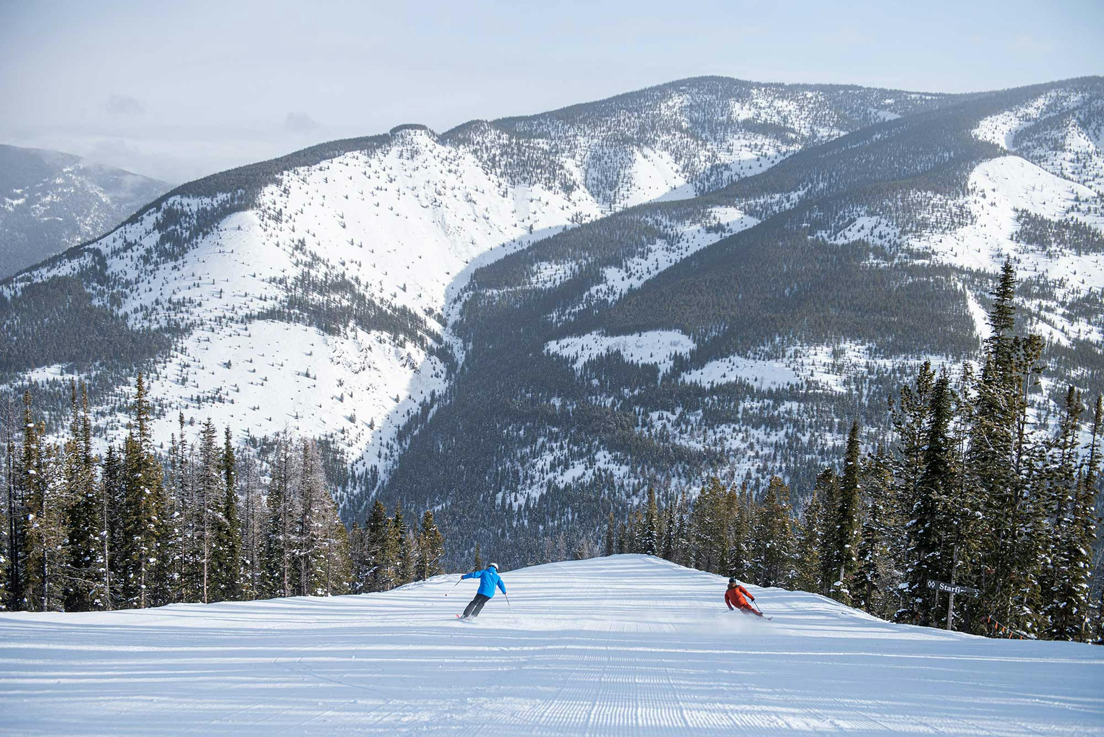 Two skiers taking in the stunning Panorama Mountain Resort scenery