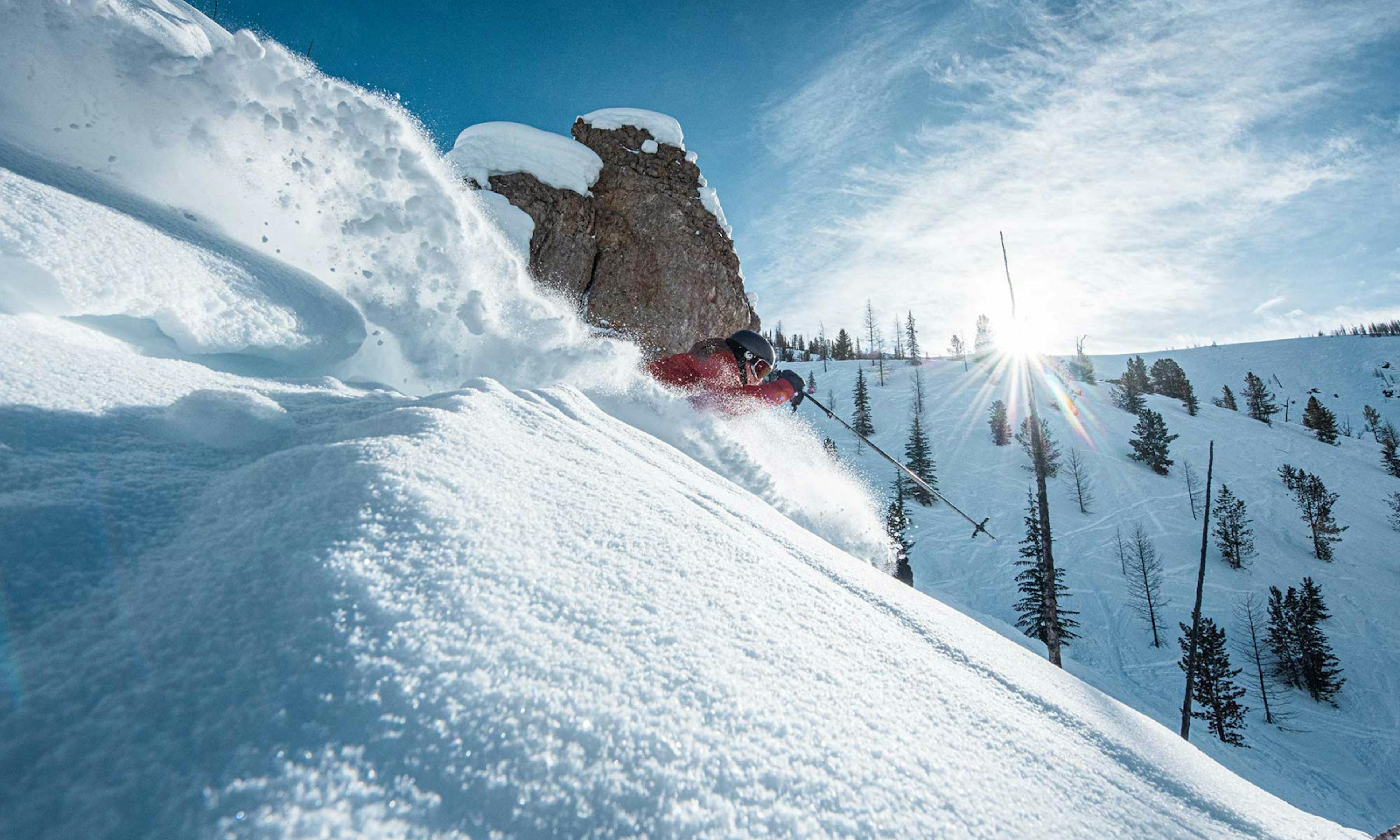 Skier in red jacket tackling the morning powder at Panorama Mountain Resort