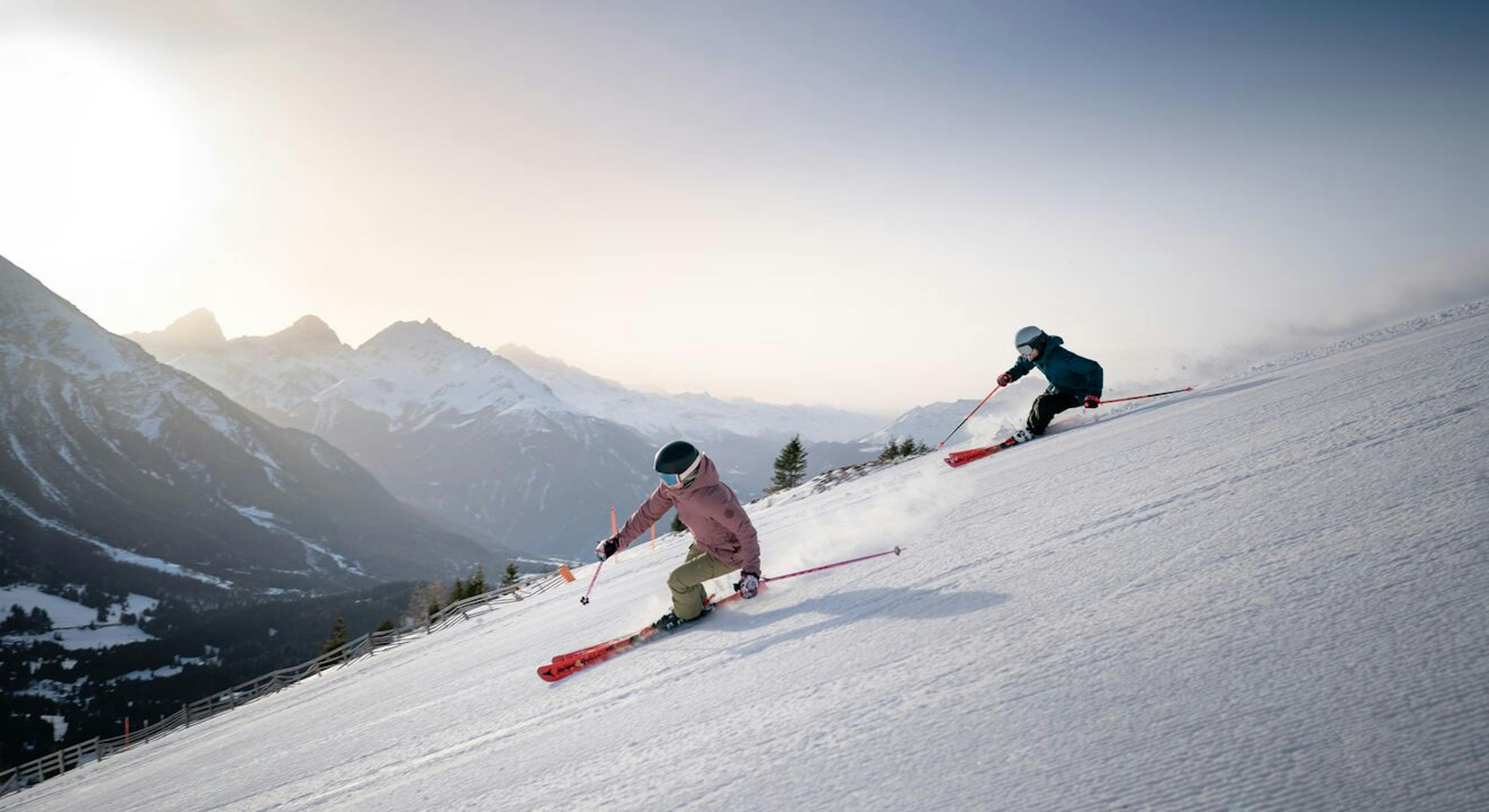 Two skiers enjoying an afternoon ski session at Arosa Lenzerheide