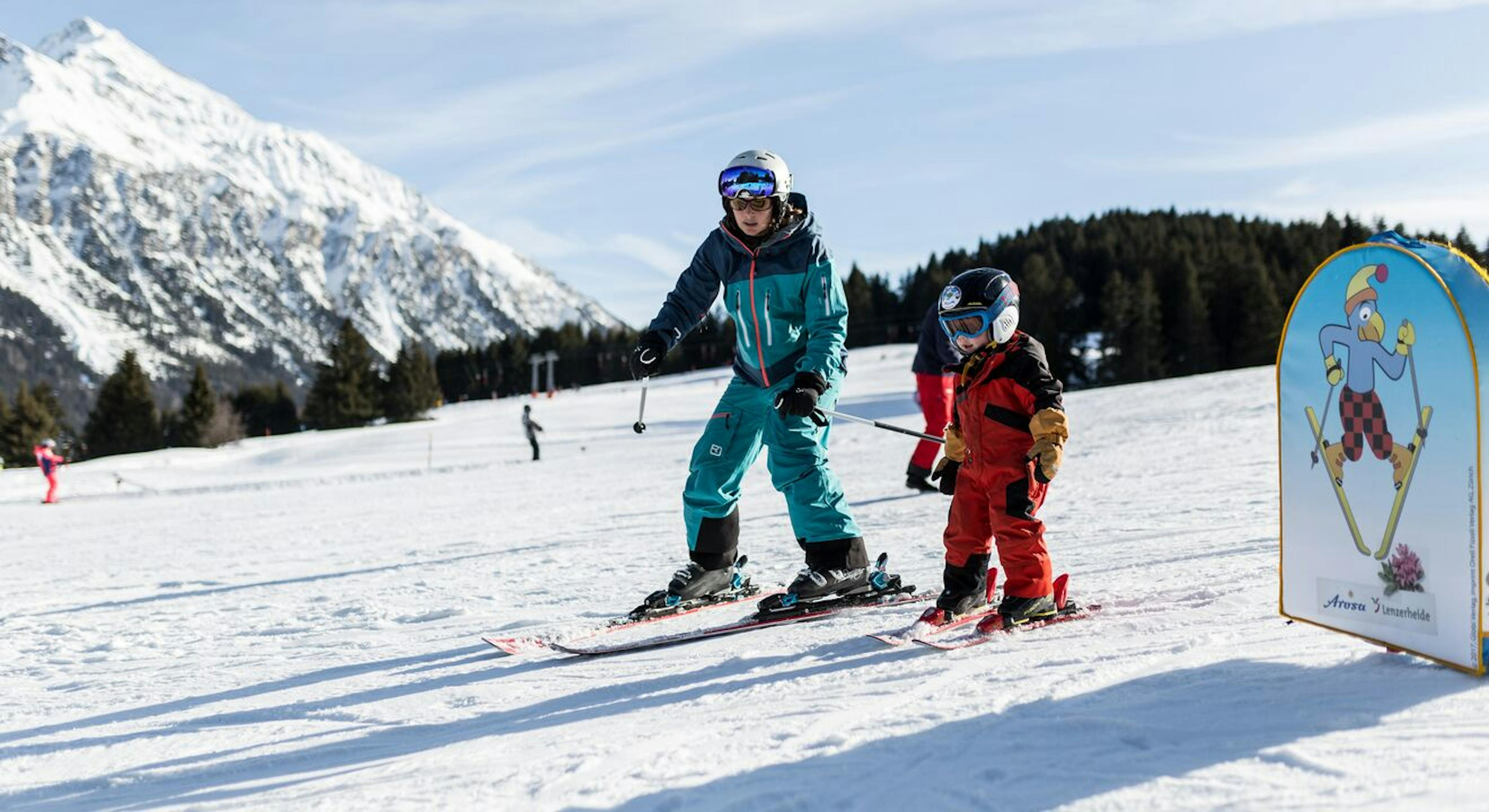 A young skier with their instructor at Arosa Lenzerheide