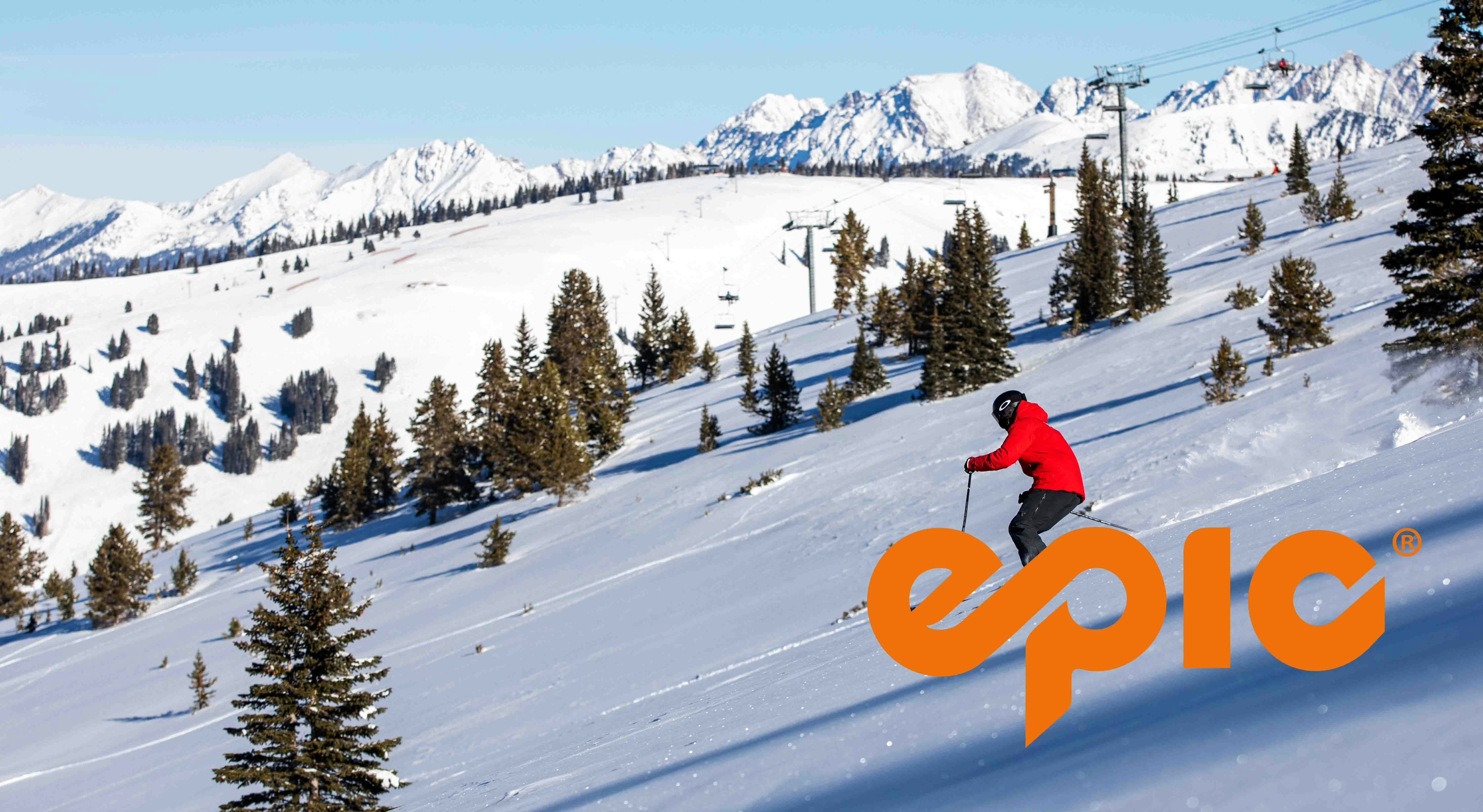 A skier glides down a snow-covered slope