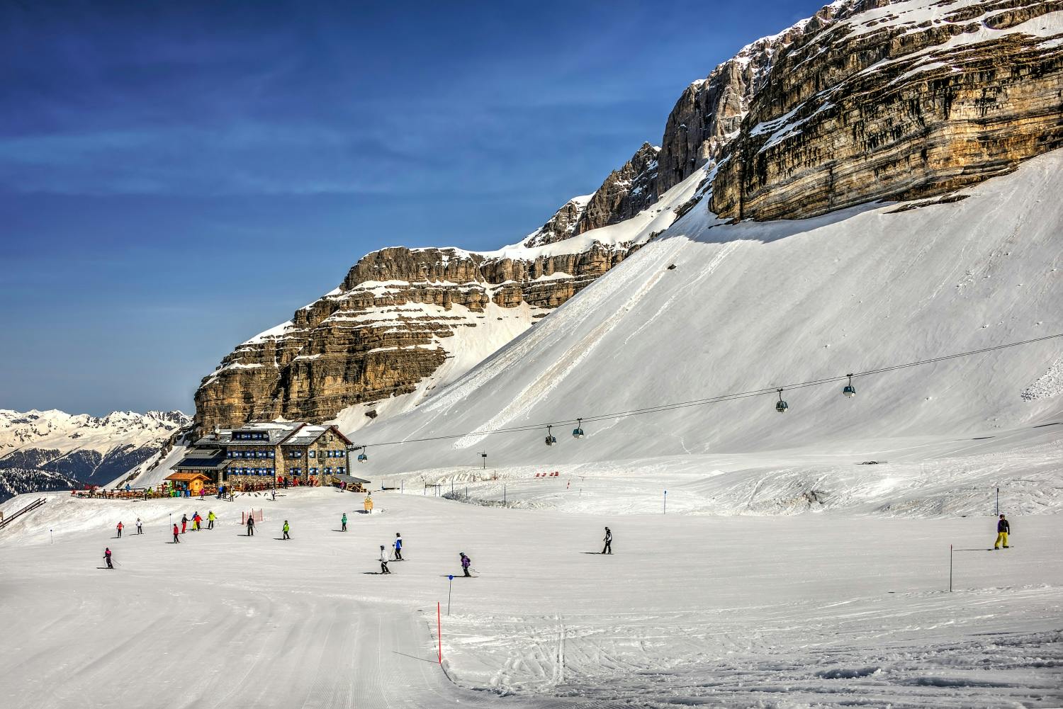 Skiers skiing the slopes of Madonna di Campiglio in Italy