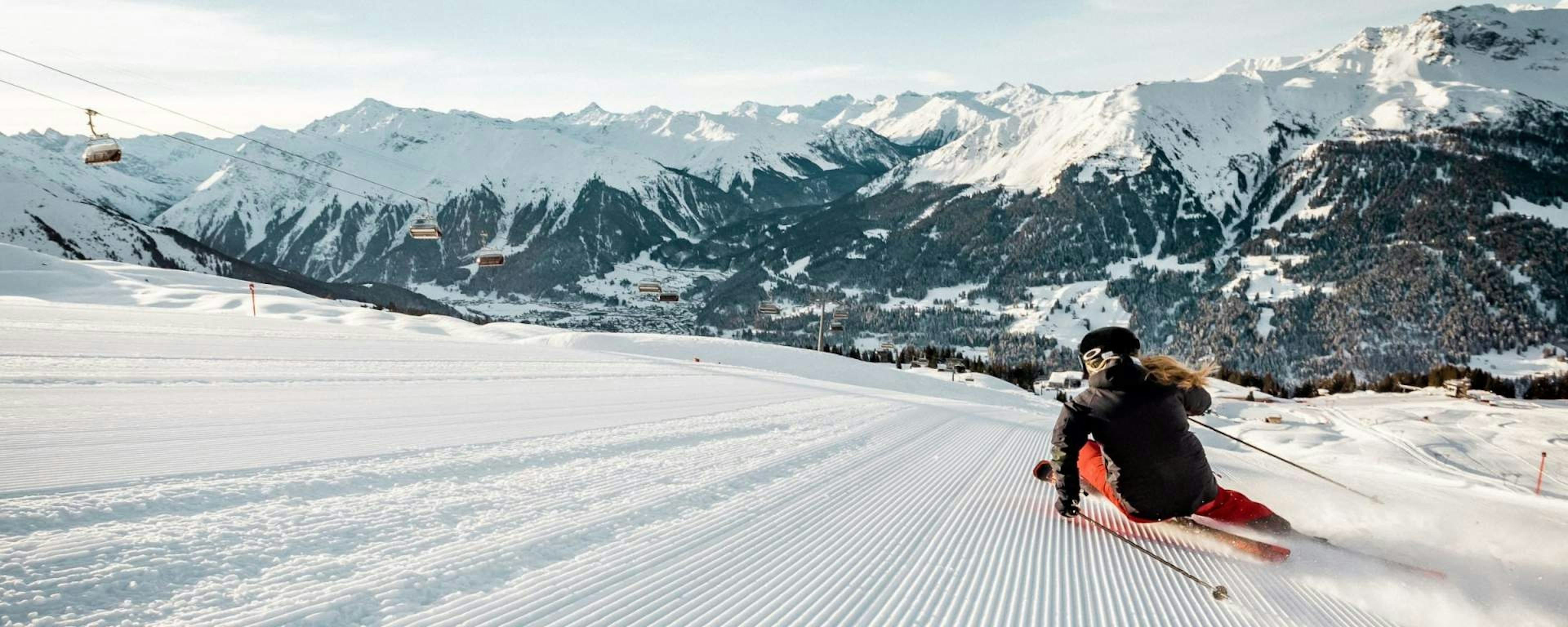 Skier of undiscernible gender hitting the slopes at Davos Klosters 