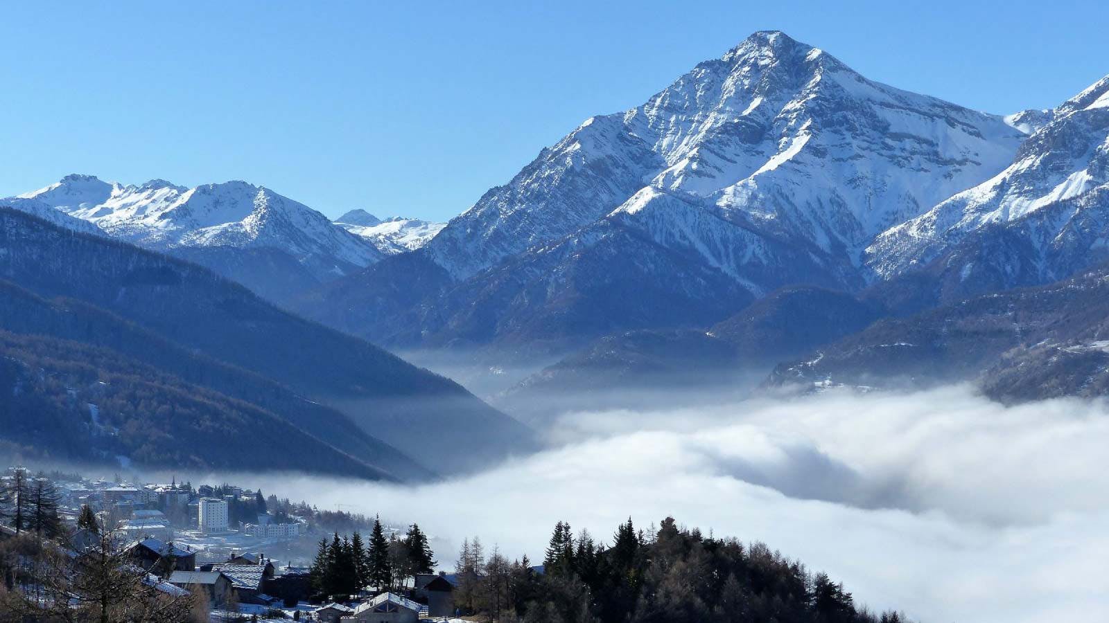 The mountain range against the morning fog at Sauze d'Oulx in Italy